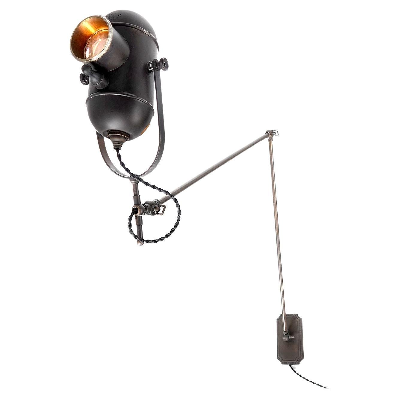 This original early medical examination lamp is signed Chiron London. We took the original fixture head and converted it into a one of a kind articulating wall lamp. It has a long reach and a unique look.