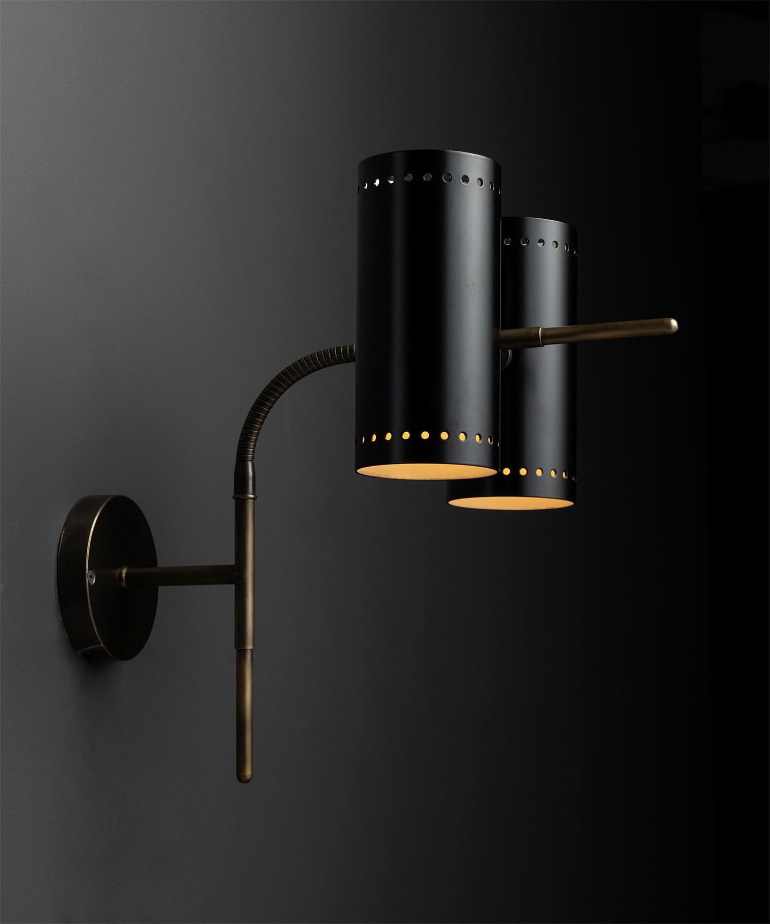 Articulating double wall sconce.

Made in Italy.

Black metal & brass fixture, with bendable arm, double light source both functional and aesthetically elegant.

Measures: 9.75”w x 15”d x 14.5”h (as shown)