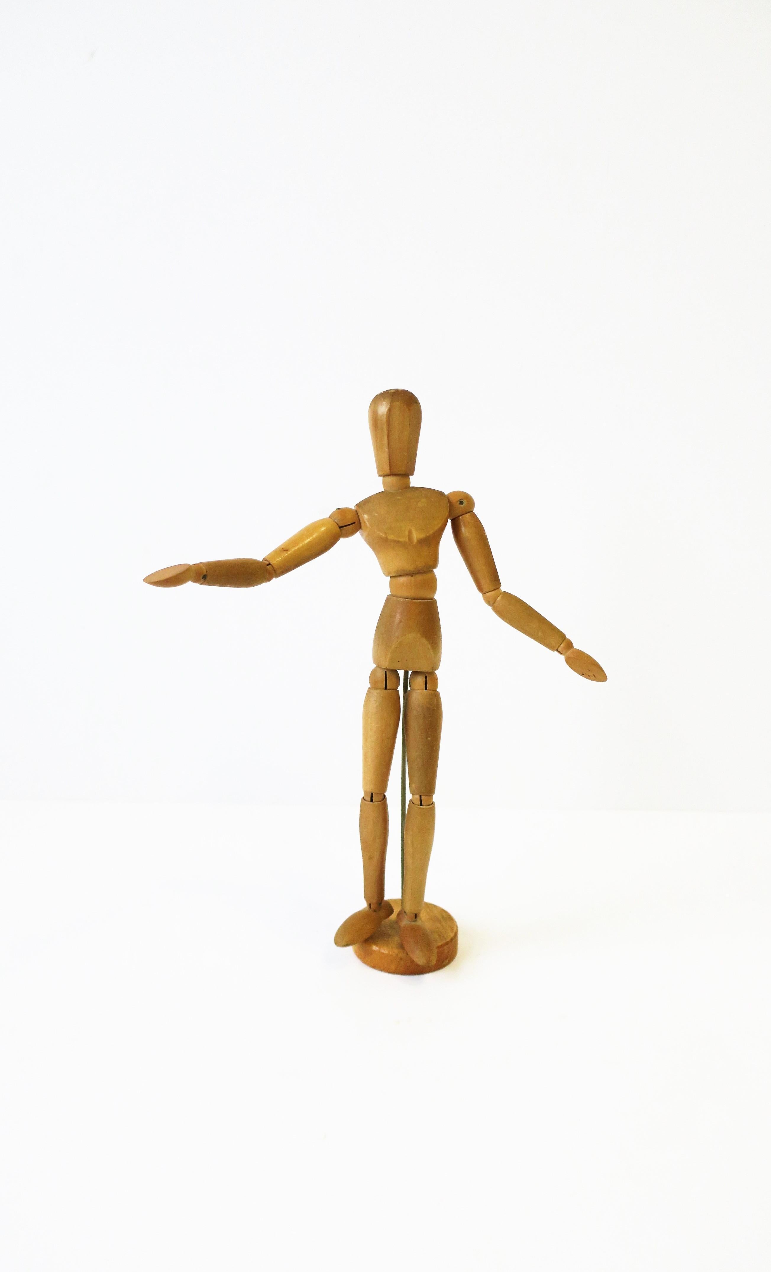 An articulating wood figure sculpture piece, circa mid-20th century. A fun, adjustable, artist model decorative object for a desk, bookshelf or other area. Measures: 3.25