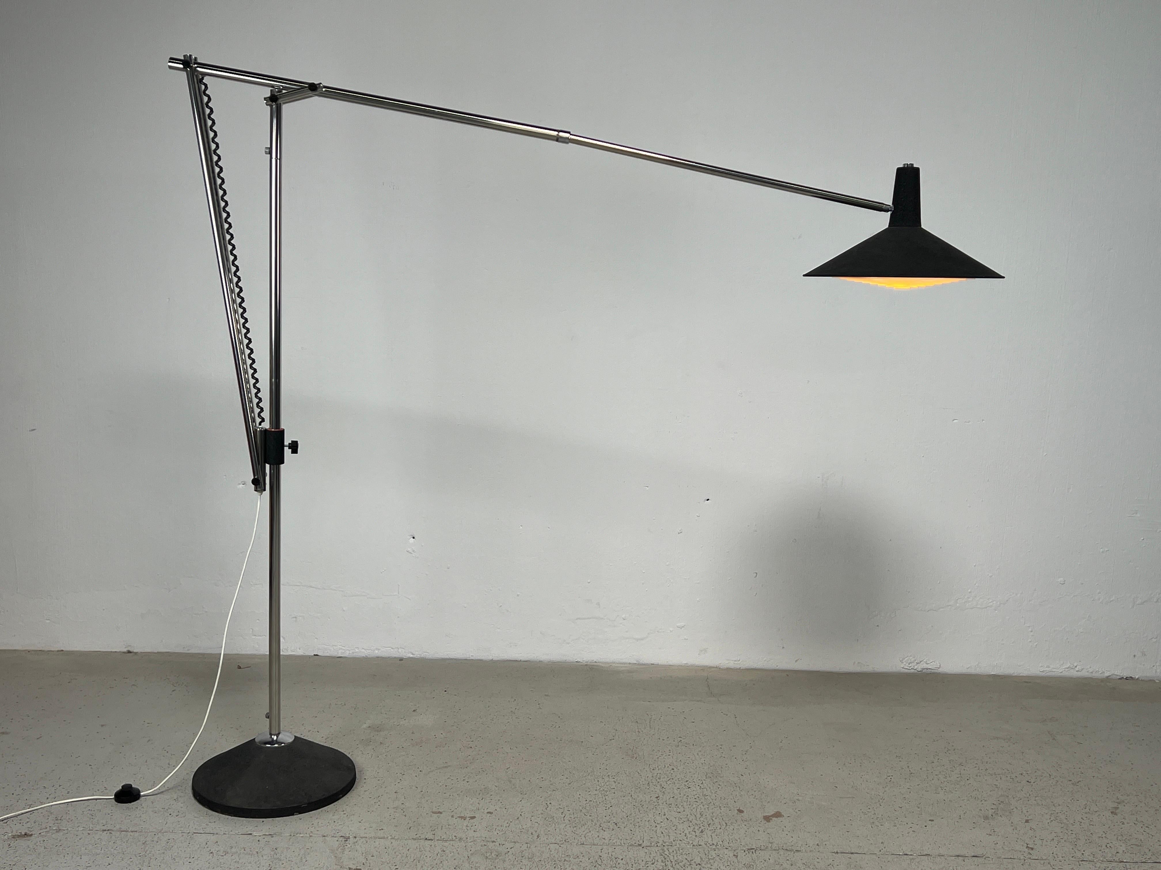 A large articulating floor lamp with telescoping arm and adjustable height. 