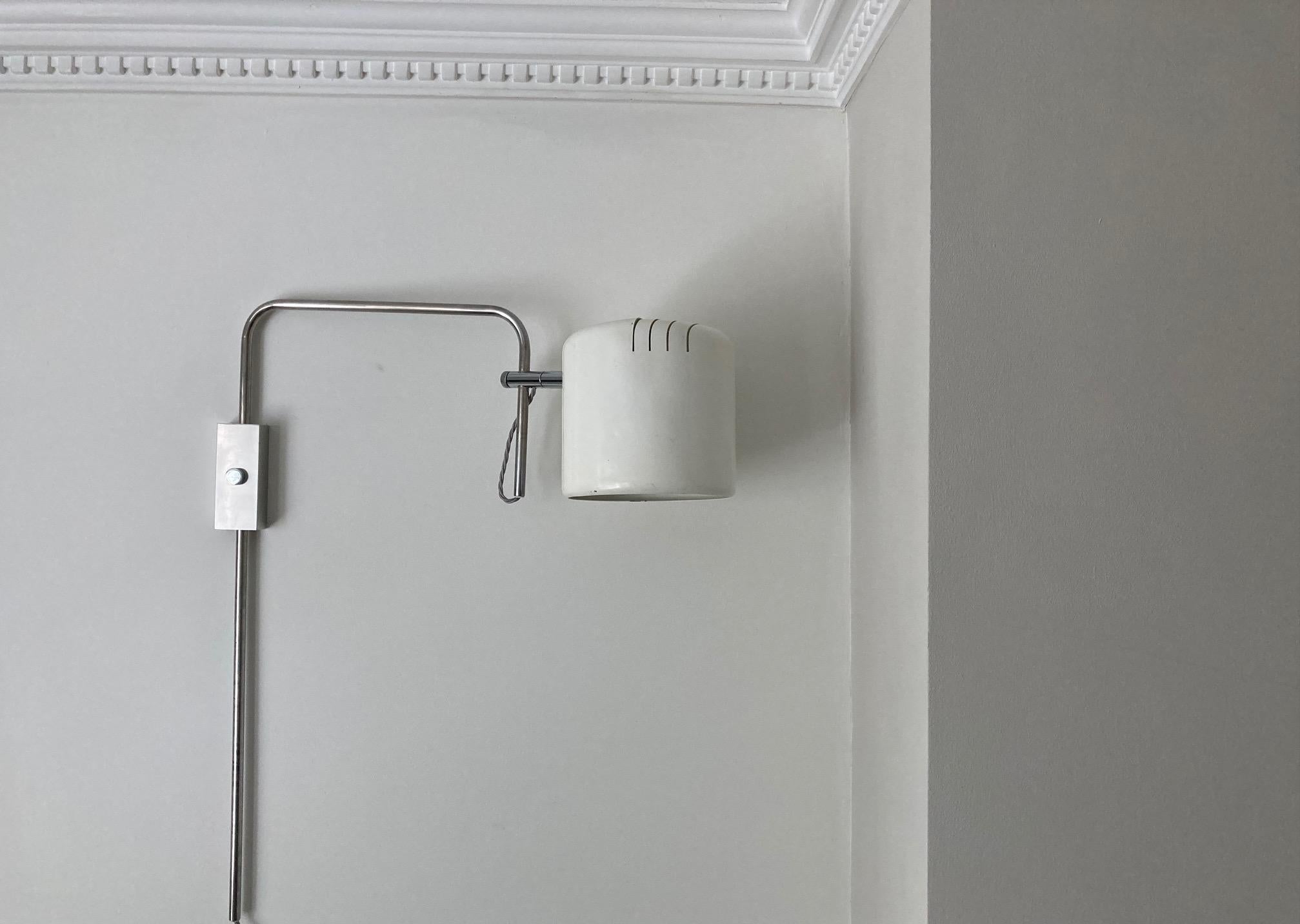 An articulating white painted enamel and chrome wall light in the manner of Joe Colombo.