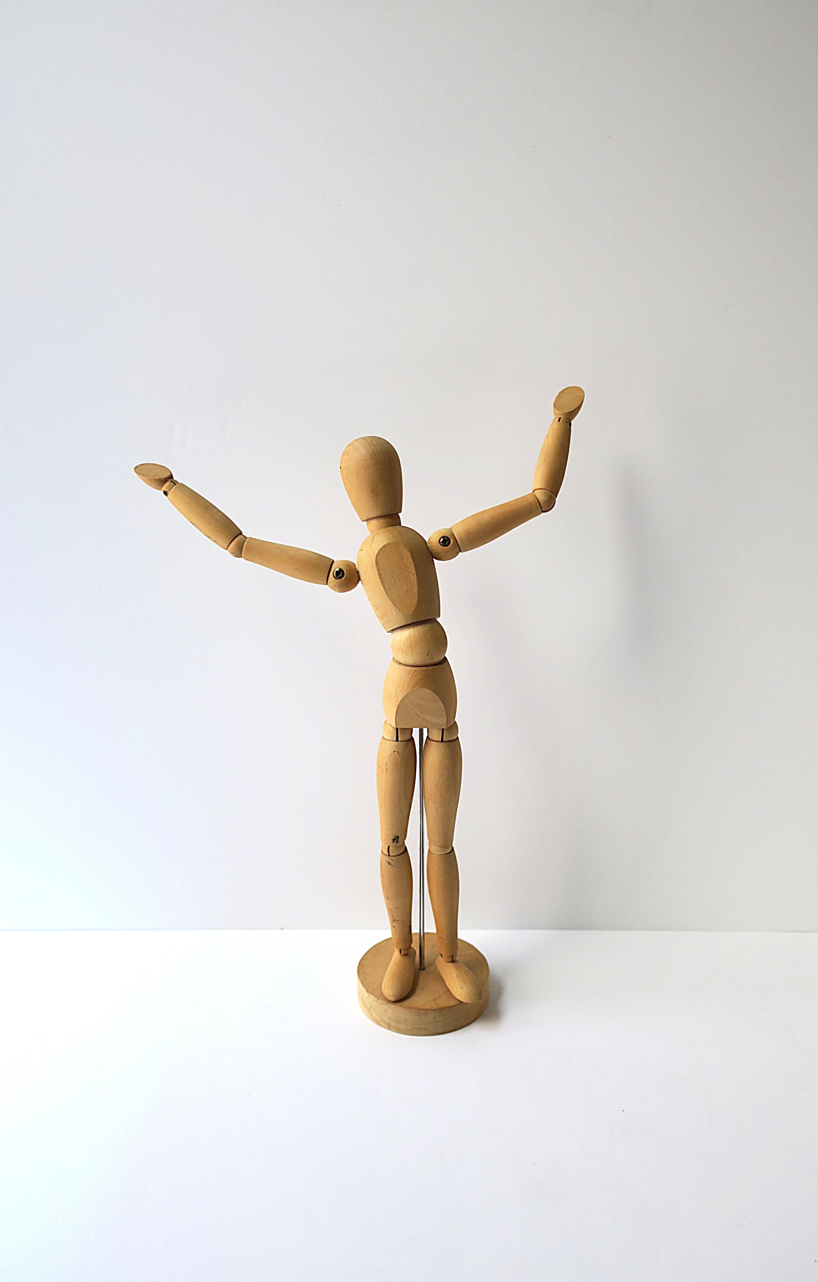 An articulating wood figure sculpture piece, circa late-20th century. Used as a tool for learning to draw the human figure since the Renaissance. A fun, adjustable, artist model for work/design and as a decorative object in a studio, on a desk,