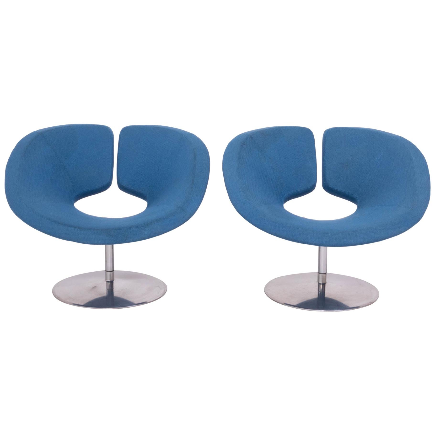 Originally designed in 2002 by Patrick Norguet for Artifort, these Apollo armchairs are a bold example of modern design.

The armchairs have a wide, sculptural form, creating a comfortable seat upholstered in a bright blue fabric.

They sit on