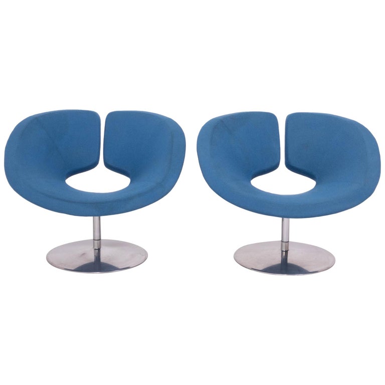 Originally designed in 2002 by Patrick Norguet for Artifort, these Apollo armchairs are a bold example of modern design.

The armchairs have a wide, sculptural form, creating a comfortable seat upholstered in a bright blue fabric.

They sit on