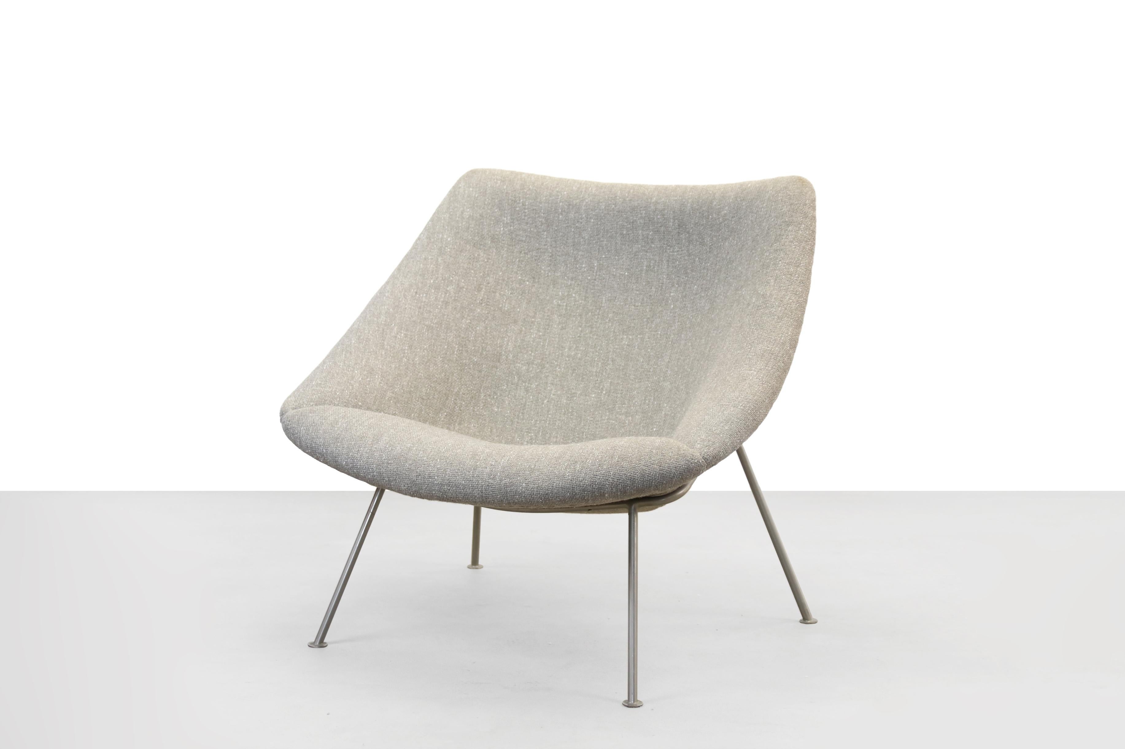 Beautiful reupholstered F157 armchair, designed by Pierre Paulin for Artifort. This chair has new foam and beautiful coarse gray beige upholstery fabric. The armchair is upholstered in the old way with blind stitch and stands on a nickel-plated