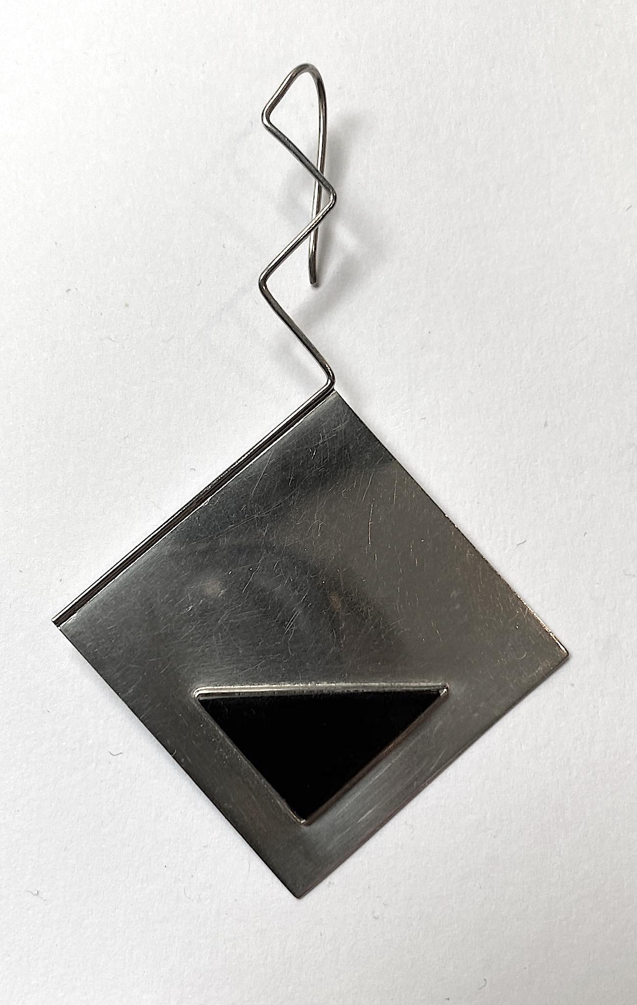 Artist made large sterling silver square pendant earrings from the 1980s. Each pendant is 1.63 inches square and set with a black onyx isosceles triangle a quarter of an inch from the bottom edges. The square pendants are turned to hang in a diamond