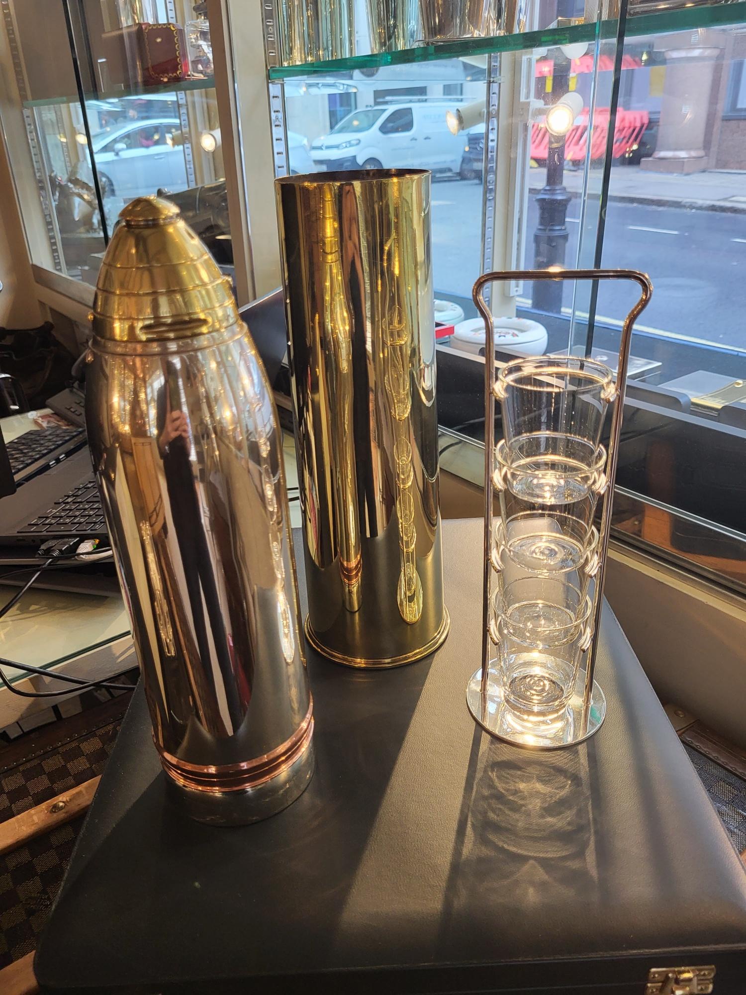 Gorham, USA

A complete pair of 'Artillery Shell' cocktail shakers by American maker Gorham, in copper, brass and silver plate, made to resemble 18lb artillery shells. 

The top section is the cocktail shaker, with pull-off cap for filling with