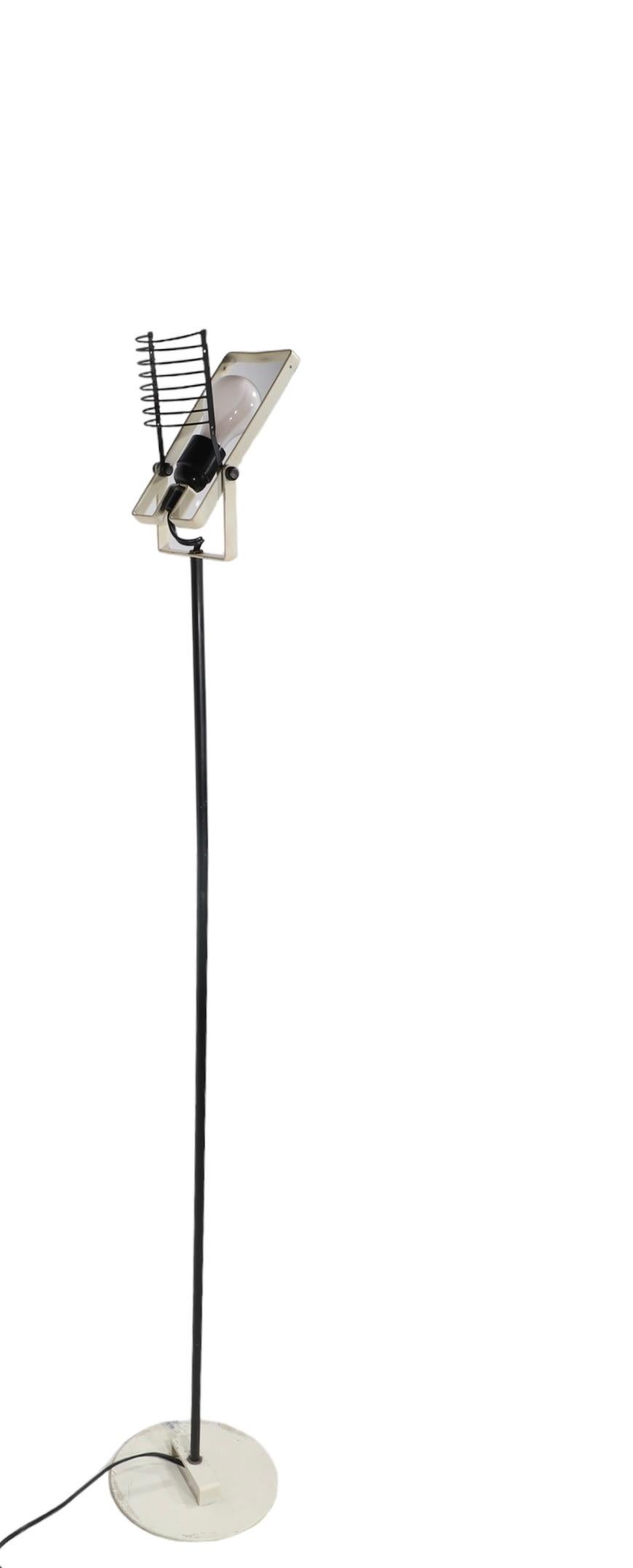 Post Modern  Italian made Sintesi floor lamp designed by Ernesto Gismondi for Artimidi circa 1970's.
 The lamp features an open cage shade, which tilts and a tilting structure which houses the bulb. This example is in good, original, working