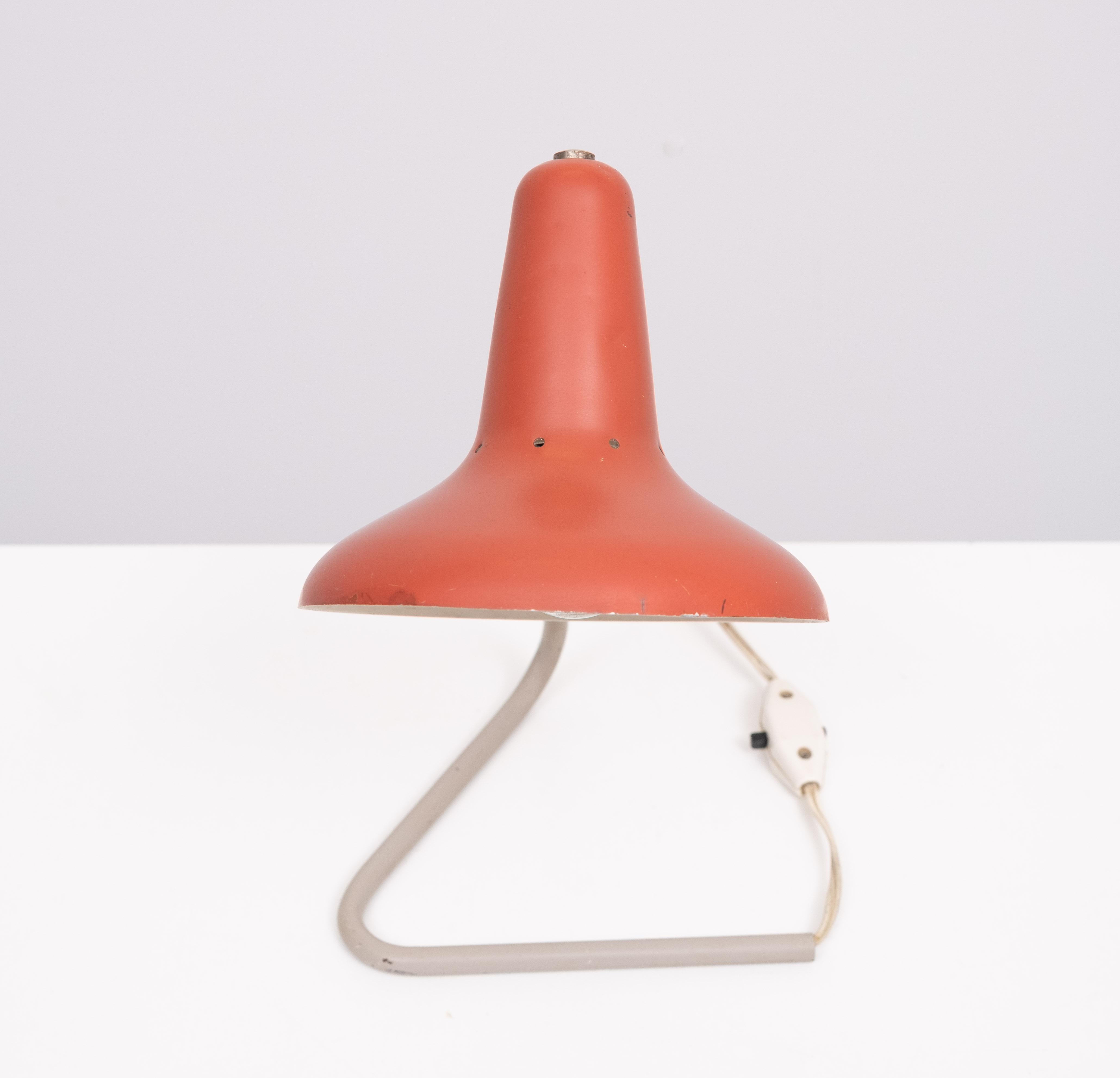 Very nice small Table lamp. Adjustable Red shade . Triangle  shaped base.
Grey color . All original . Unique and rare model . small socket bulb needed.