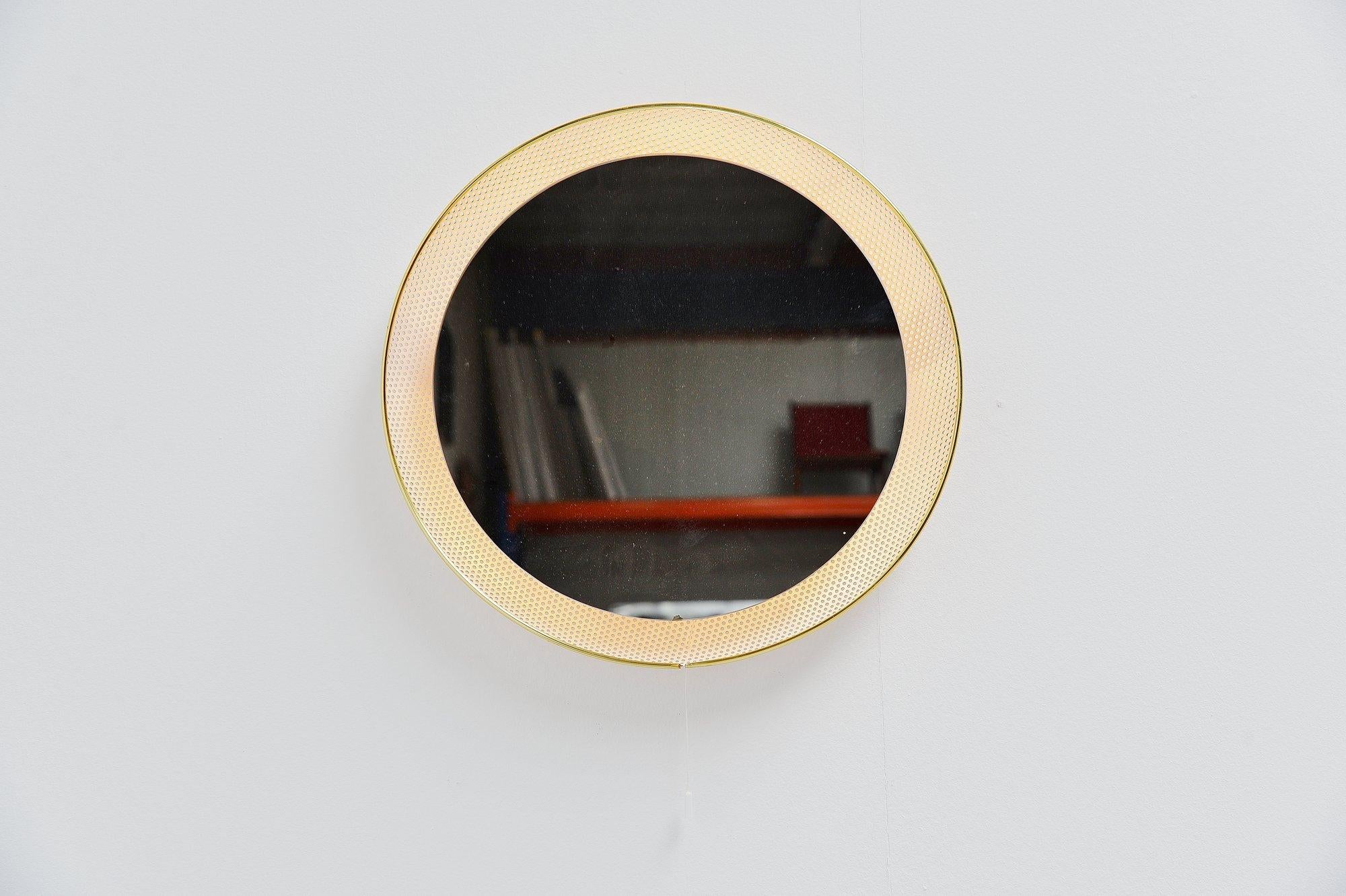 Very nice and decorative round illuminated wall mirror designed by Floris Fiedeldij made by Artimeta Soest, Holland, 1960. These mirrors are often sold or attributed as Mathieu Matégot mirrors. This is a white painted mirror, fully die cut back.