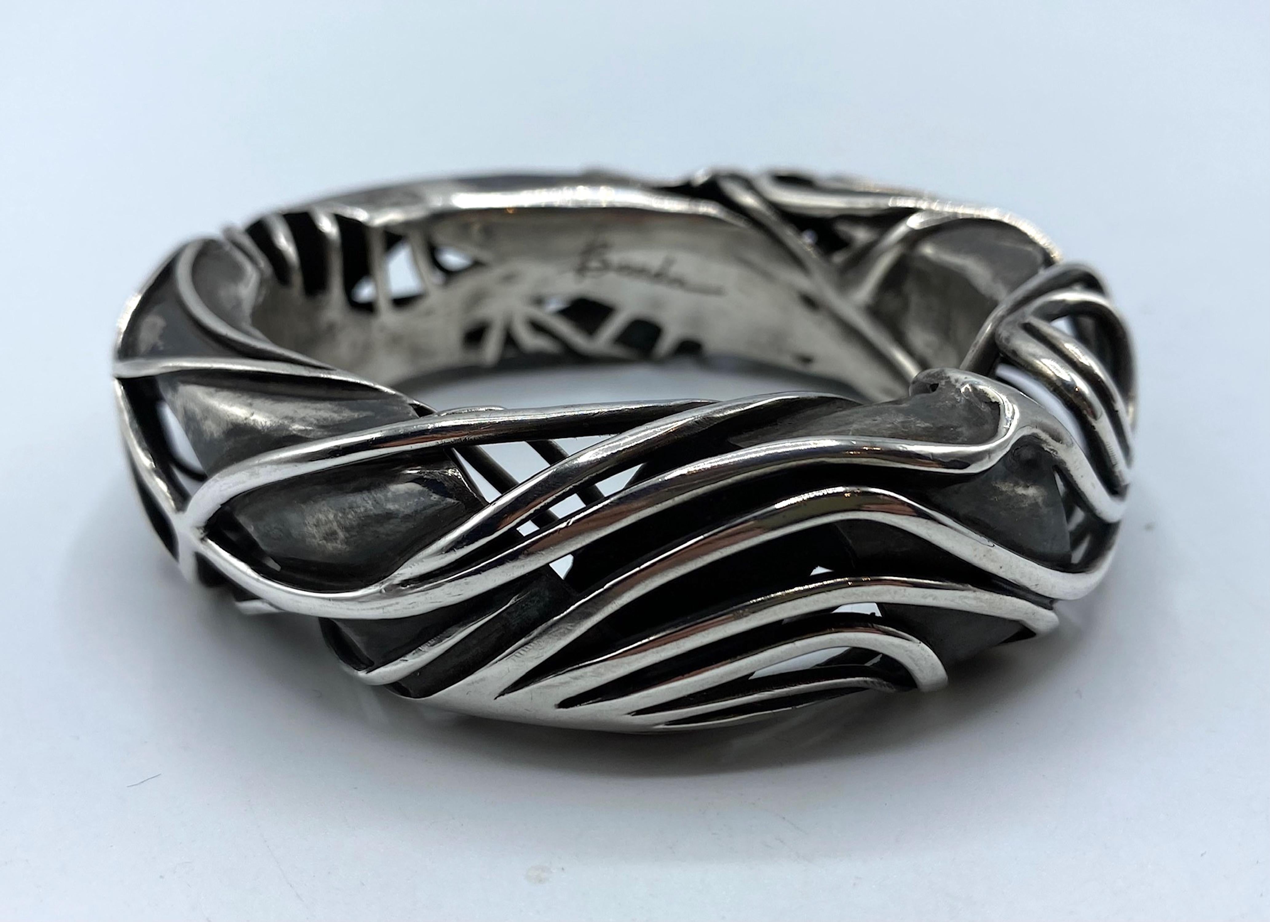 Artisan made silver bracelet in an abstract design. Signed Barda, the bracelet has no other markings. It was professionally tested with a metal evaluator for jewelry and is 930 parts of sterling silver. This is higher than the standard 925. . It has