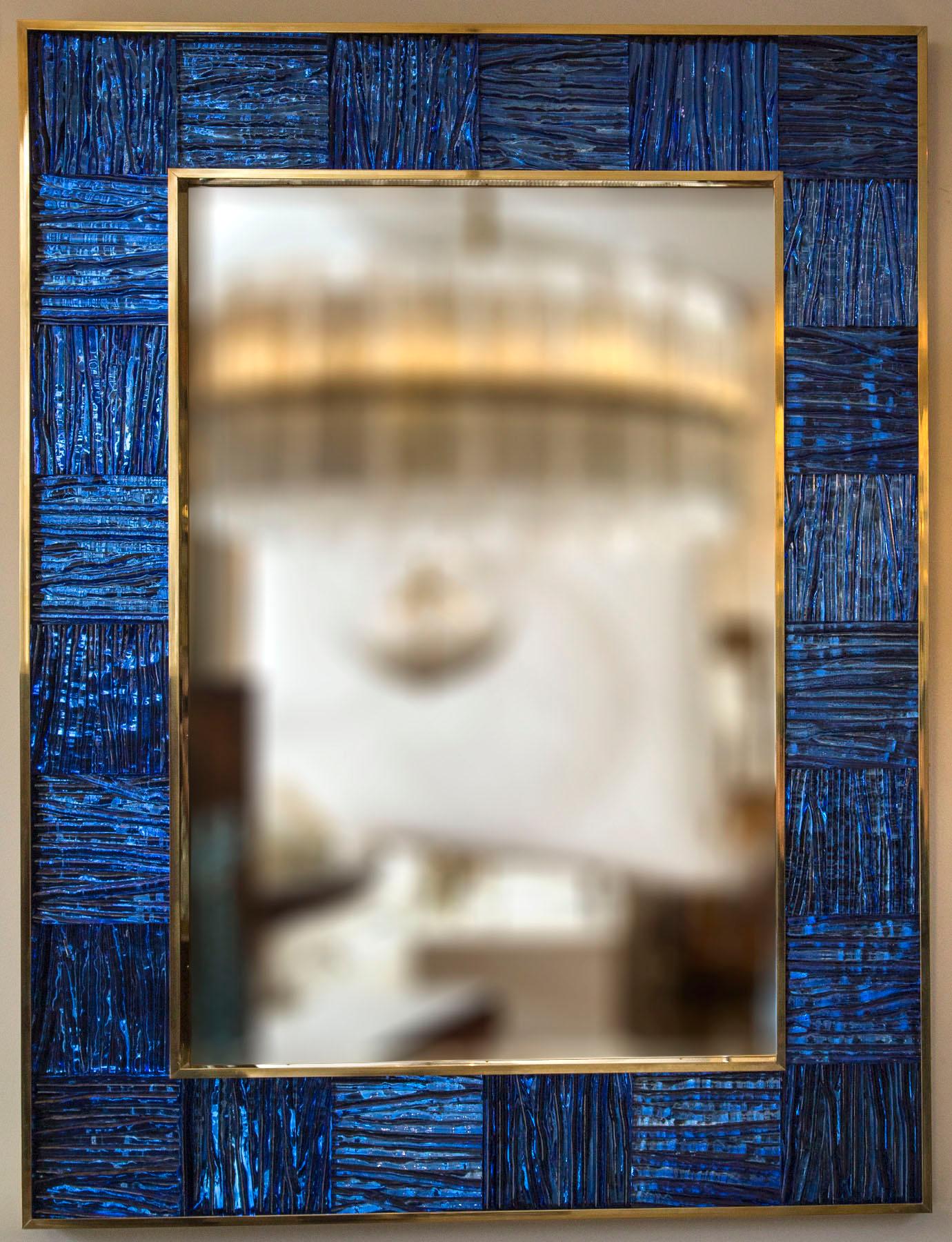 Striking un-lacquered brass framed mirror inset with thickly blown wavy textured glass panels in a beautiful blue tone, artisan metal and glass work. Weight 70-75 lbs
1 available or customize-able in size and color
Date: contemporary
Origin: