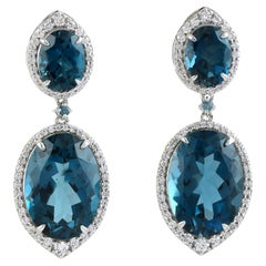 Orecchini pendenti artigianali in topazio blu con diamante in oro bianco 14 carati