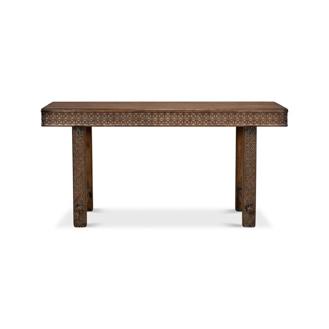 Featuring intricate geometric carvings that whisper tales of ancient craftsmanship. Fashioned in antiqued and distressed pine wood, this console table boasts a robust structure, promising to stand the test of time in both durability and