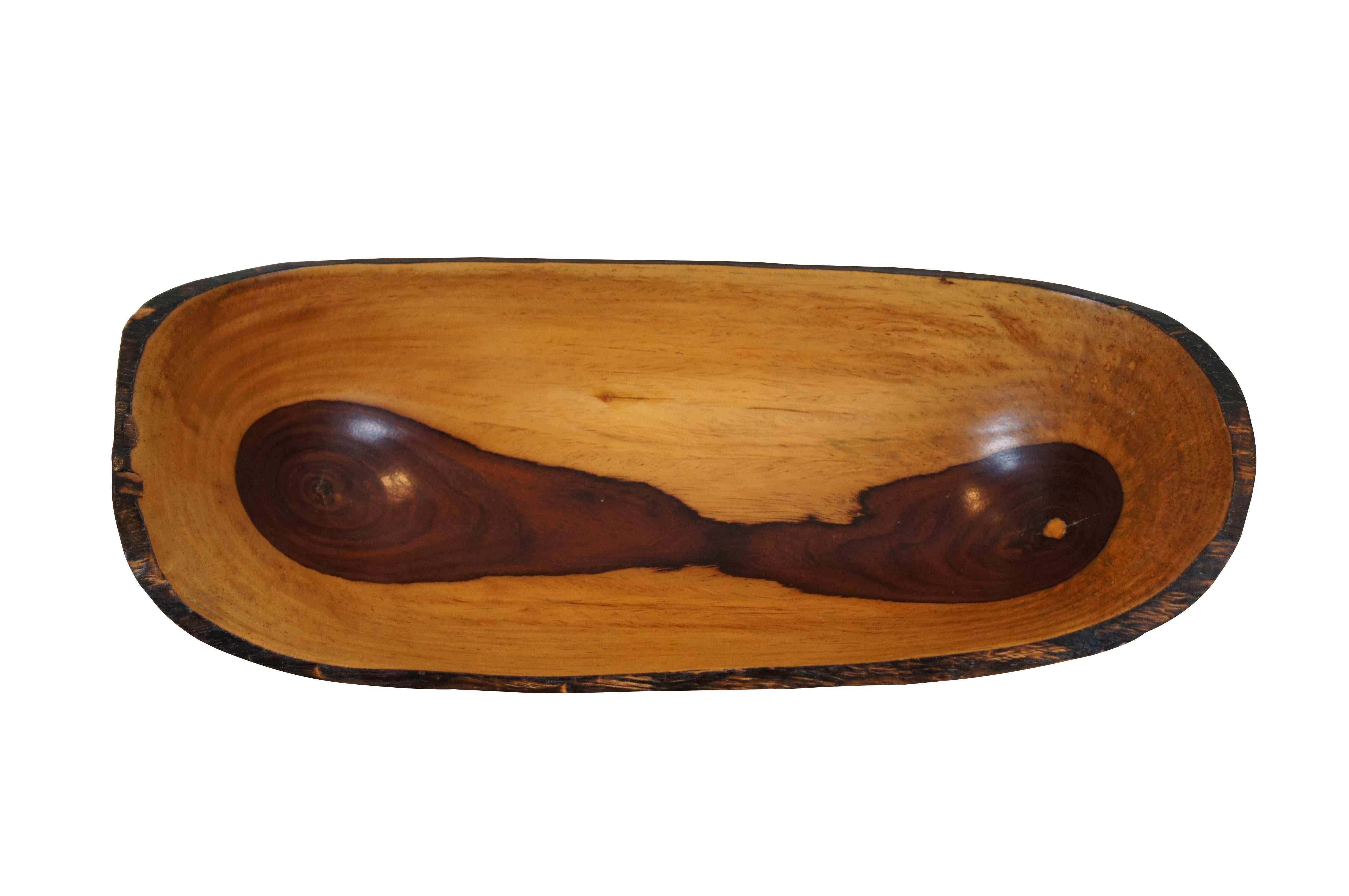 Vintage artisan carved fruit / bread / centerpiece serving bowl.  Made of olivewood featuring oval form with live edge and natural tones.

Dimensions:
16.5” x 7.25” x 5” (Width x Depth x Height)
