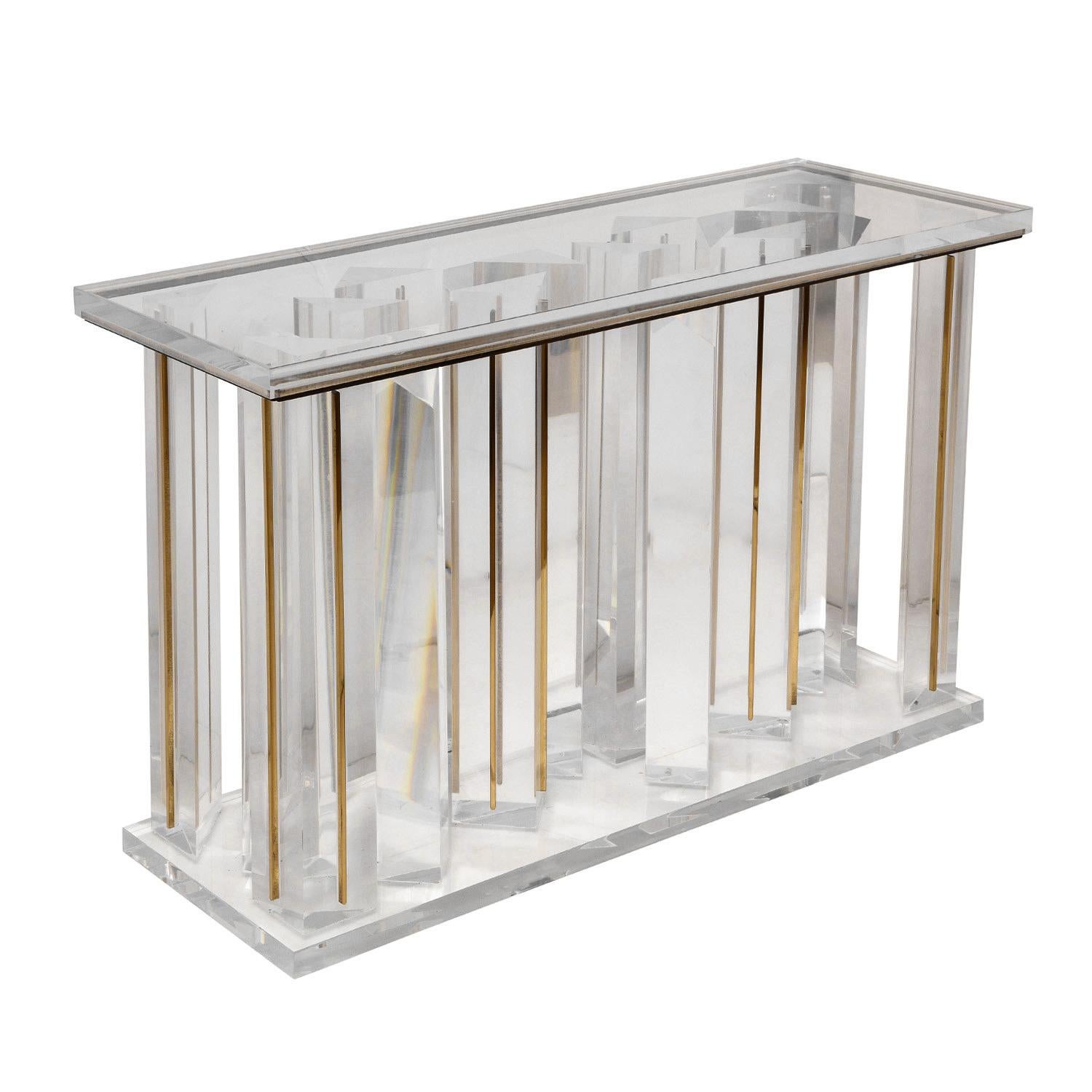 Beautifully crafted console table in solid Lucite with sculptural vertical elements with brass accents, custom design, American 1970's. Impeccably crafted and highly detailed. 