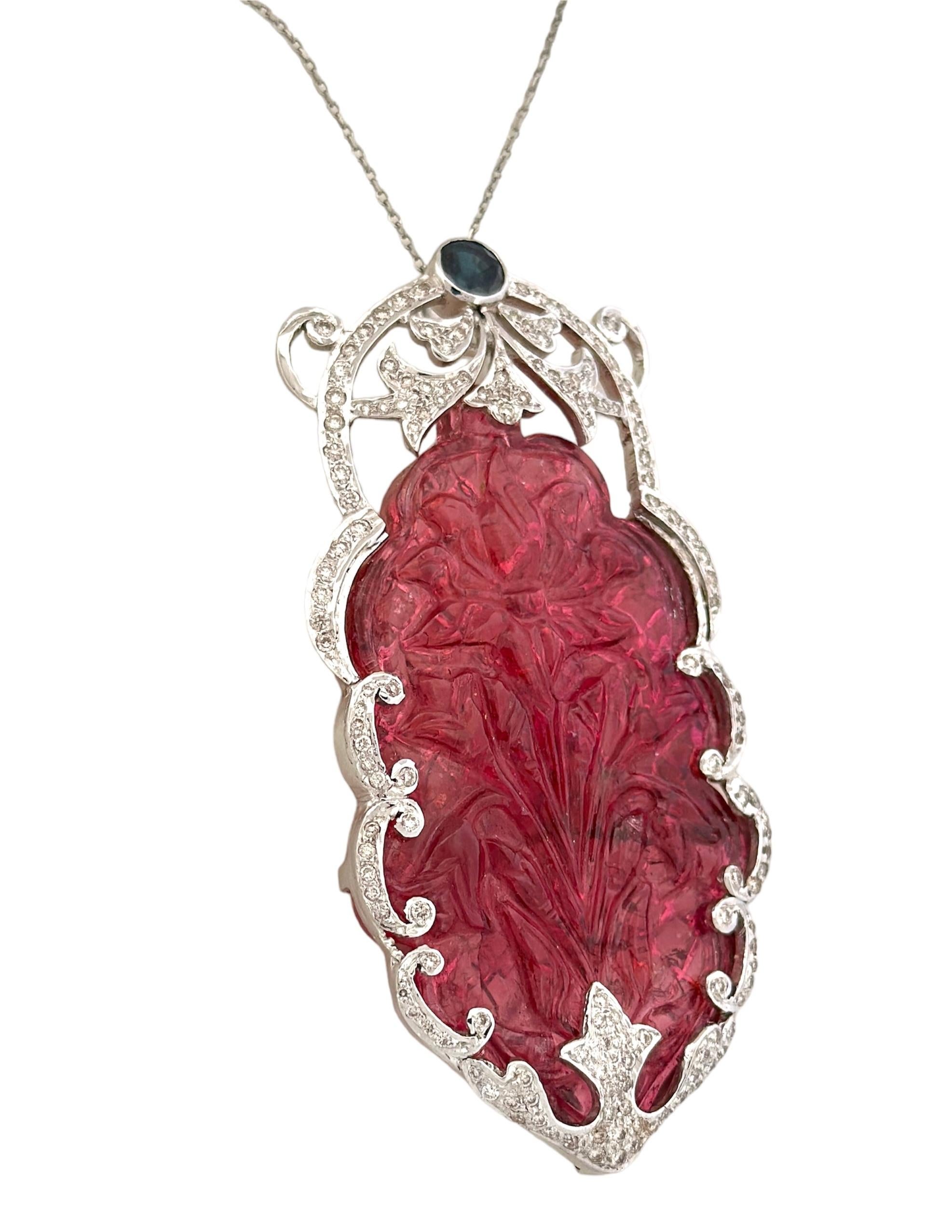 This Hand-Engraved Tourmaline Pendant is a remarkable piece from the early 20th century, a true testament to the craftsmanship of that era. Weighing in at a substantial 31.19 grams, it not only exudes an air of luxury but also carries the historical