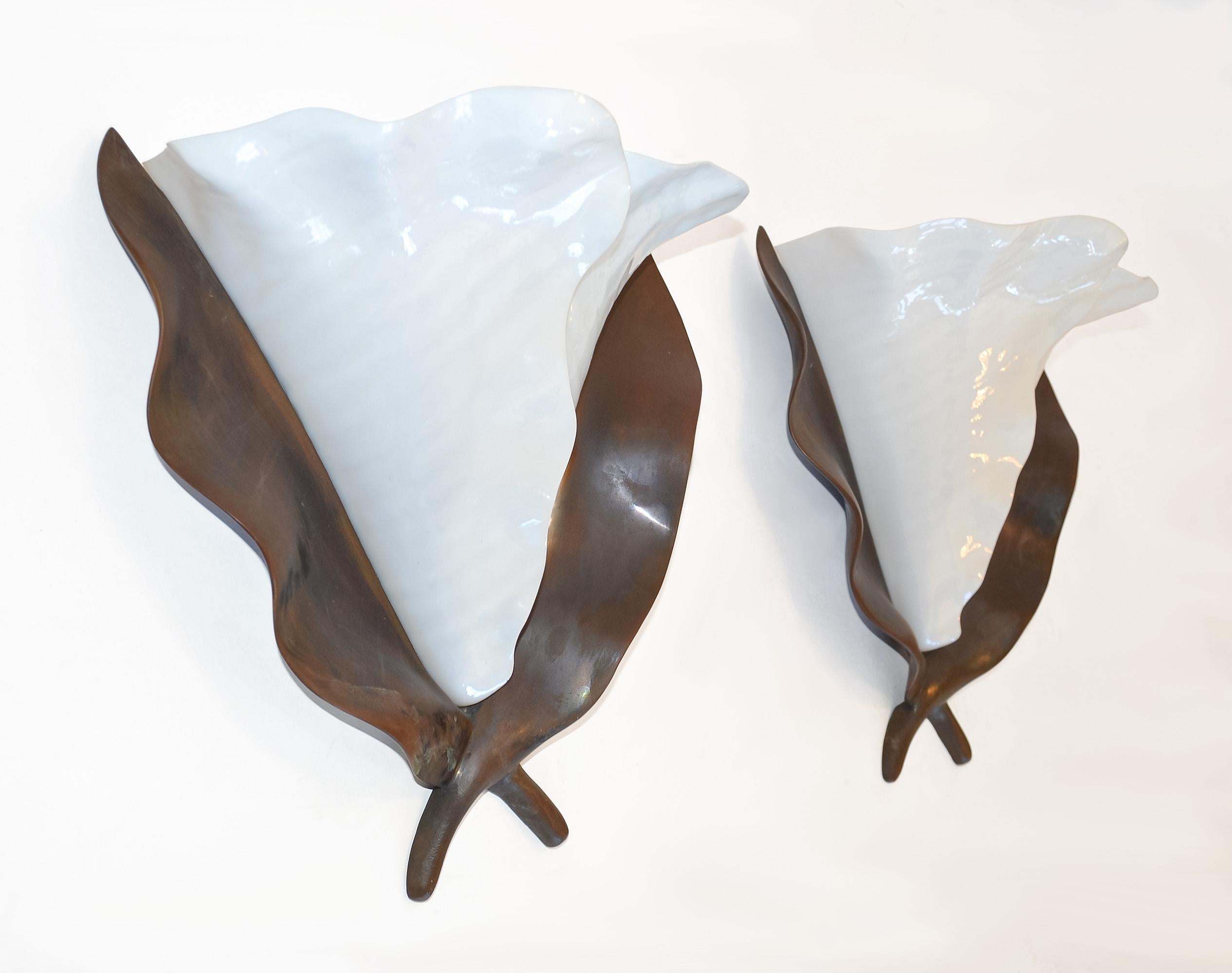 Artisan-crafted Organic Bronze and Glass Sconces by Hilliard Lamps, USA, 1980s

Resembling abstract Lilies with cast bronze leaf-form backplates with warm patinated finish, each fitted with a pair of molded, scalloped white glass petal shades in a