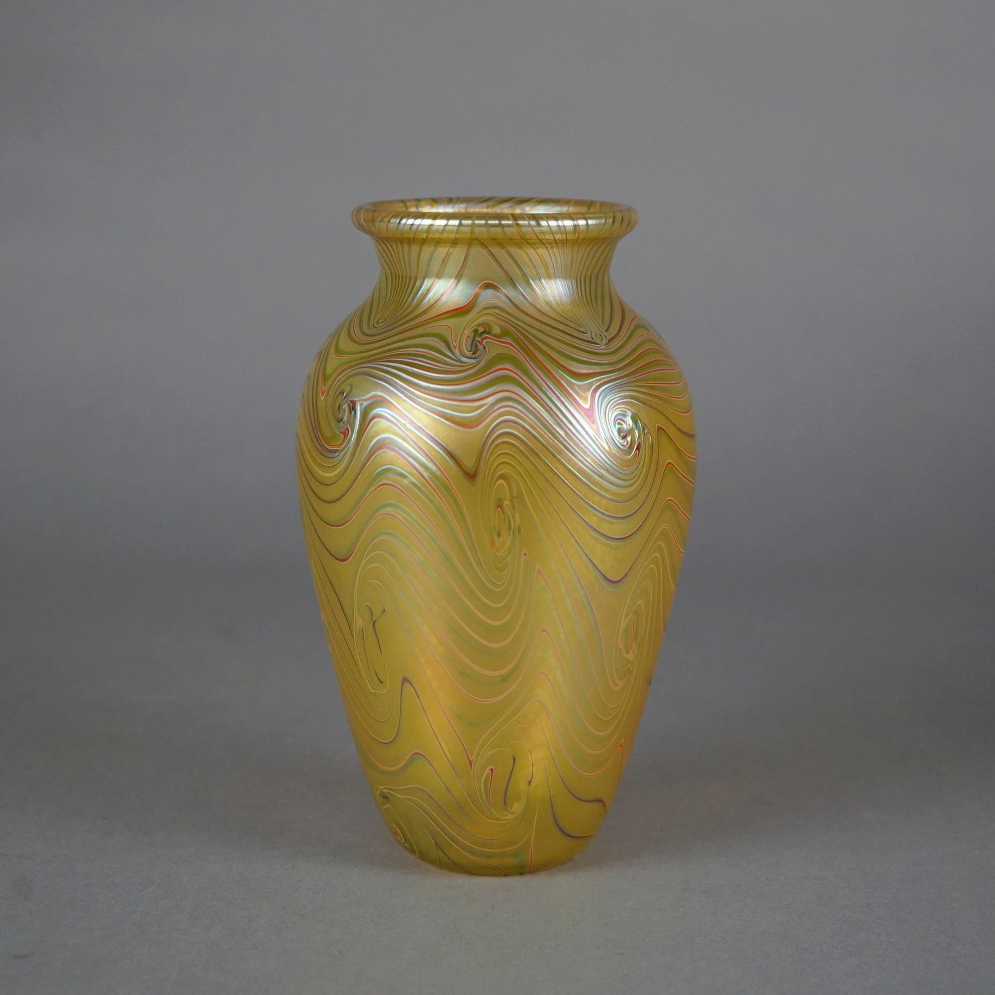 An artisan crafted vase by Orient and Flume offers art glass construction with chocolate swirls on gold ground, original label and dated as photographed, 20th century

Measures- 8'' H x 4.5'' W x 4.5'' D.