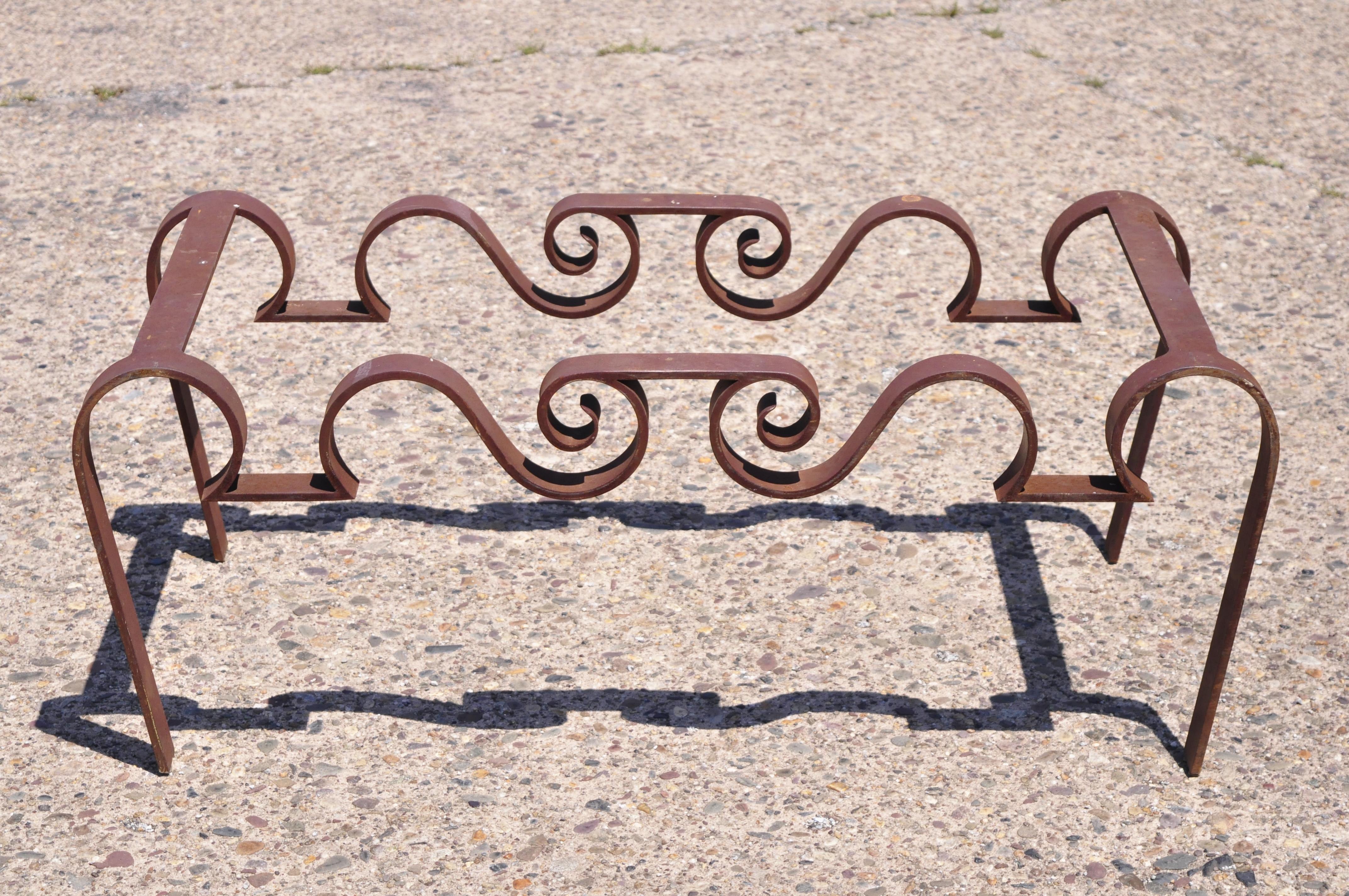 Vintage artisan crafted wrought iron Hollywood Regency sculptural ribbon scroll coffee table base. Item features heavy cast and wrought iron construction, weathered, rusty original finish, very nice vintage item, quality craftsmanship, sleek