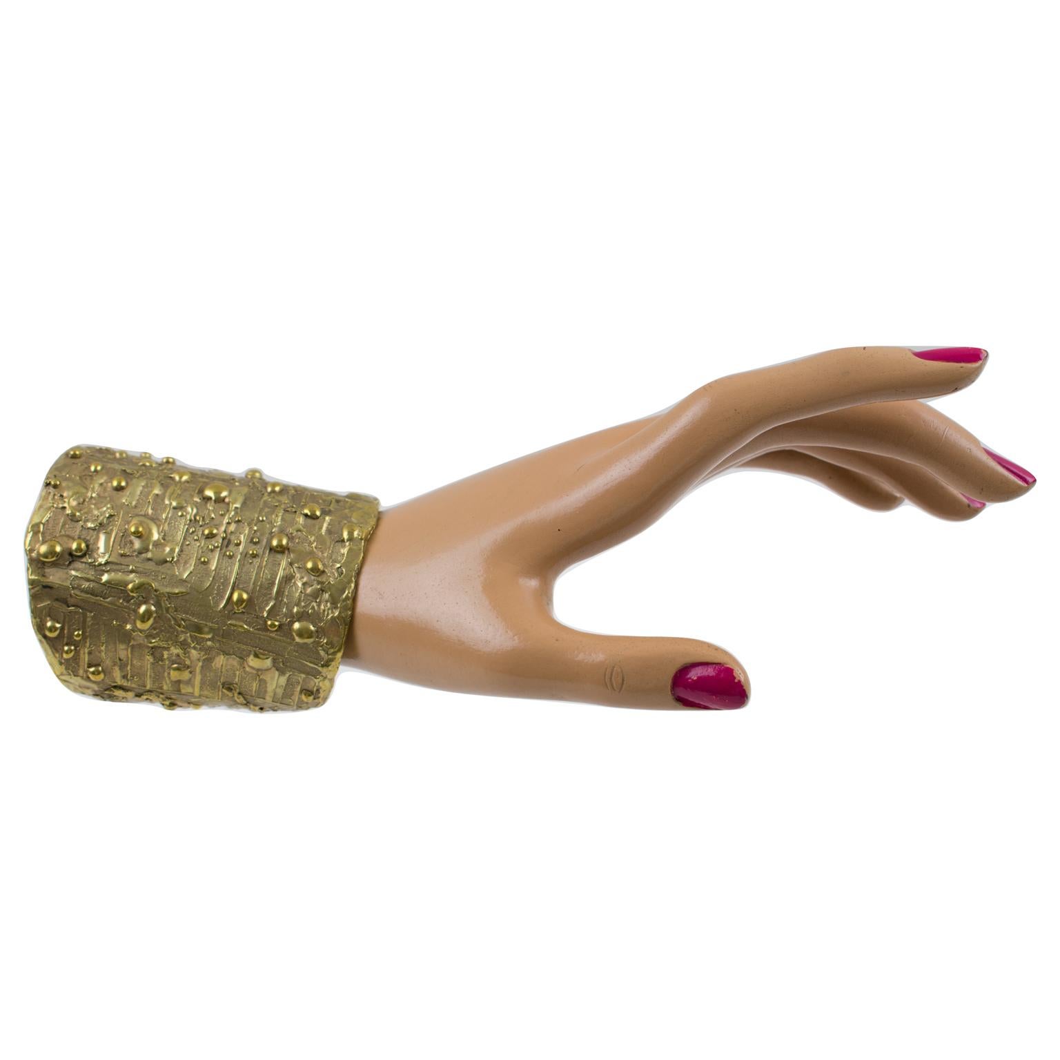 Striking modernist brass cuff bracelet by French designer studio. Chunky massive oversized hand-made bangle with brutalist carving and organic feel design. No visible maker's mark.
Measurements: inside across is 2.32 in. diameter (5.8 cm) - Opening