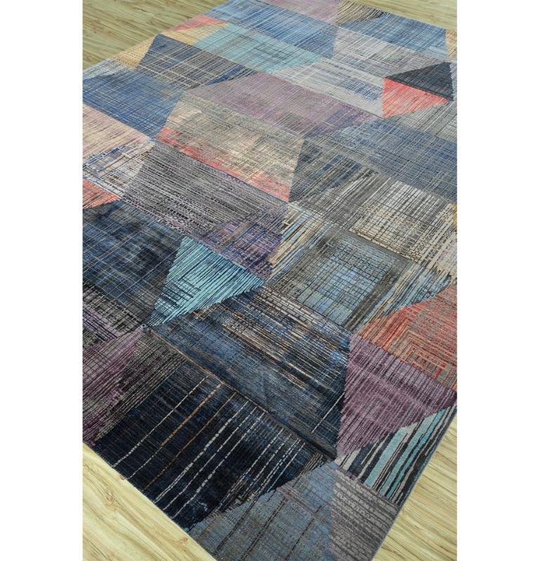 In every knot and thread, our hand-knotted rug whispers tales spun from the very essence of wool. The dance of charcoal gray and faded denim paints a canvas that transcends dimensions. The handknotted rug, a symphony of design, beckons you to