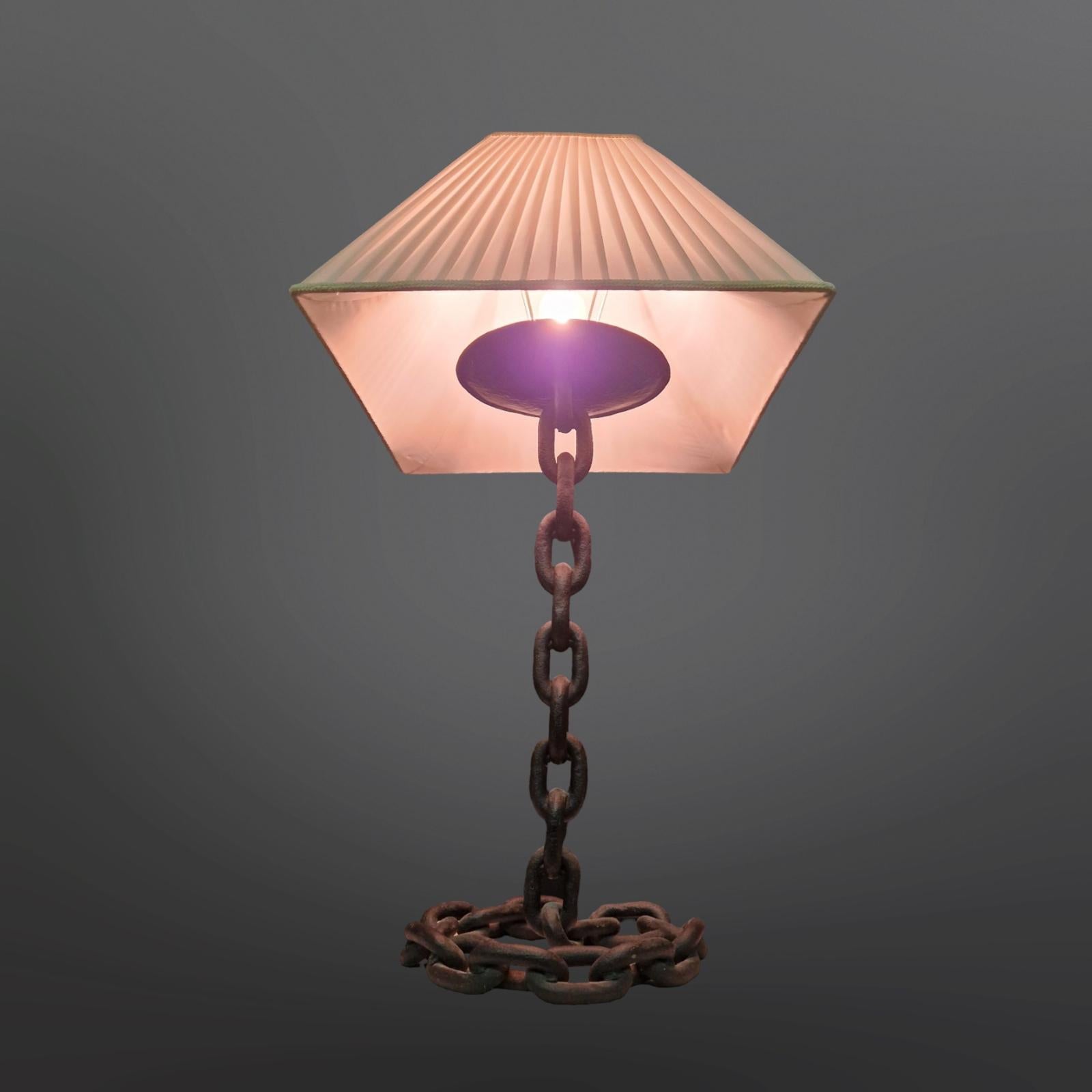 Large brutalist style table lamp. Made from a heavy iron chain. The links have been welded to each other creating the illusion that it is defying gravity. Made in France somewhere in the 1960s. 
The lamp is sold without the shade shown on the