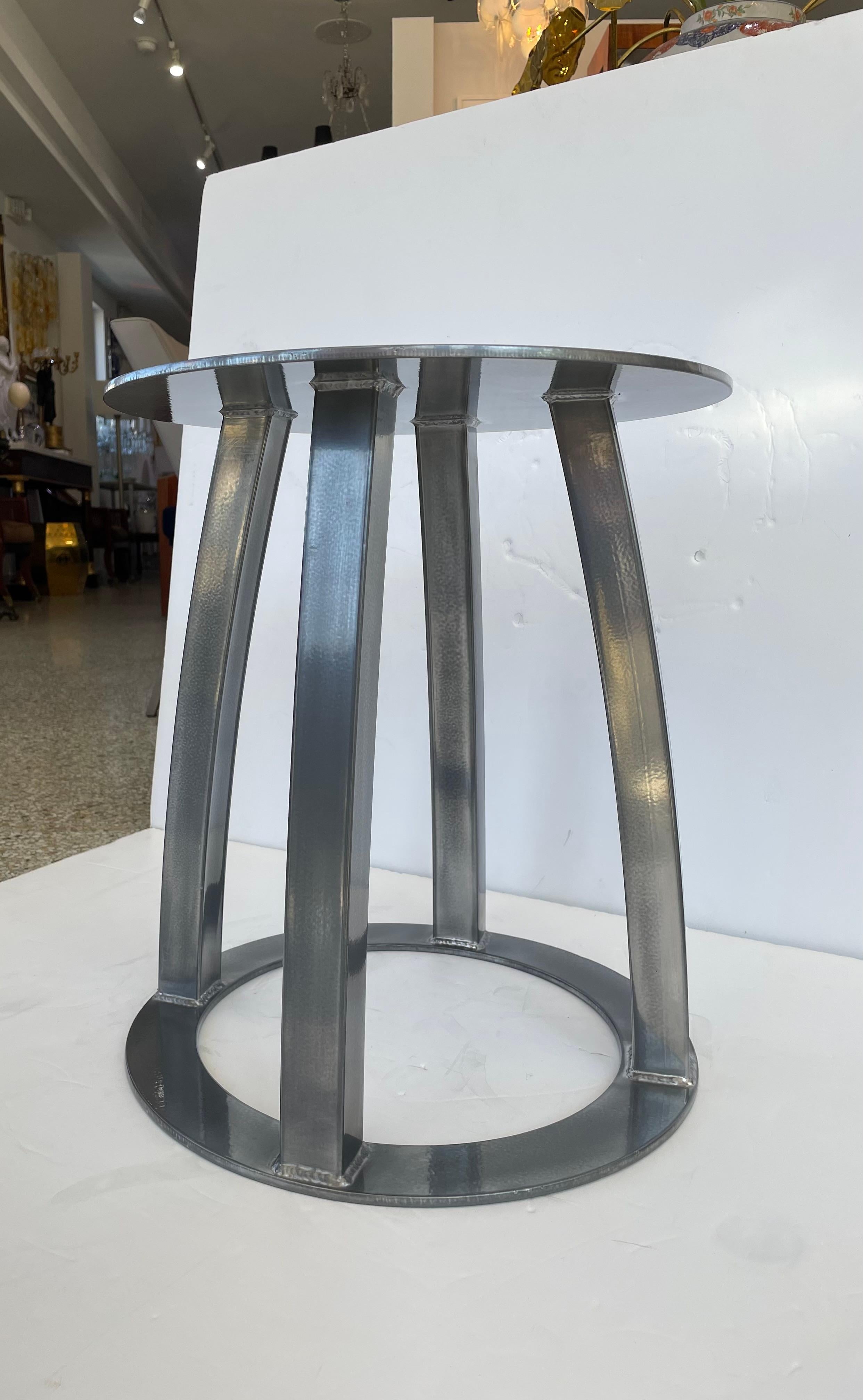 This stylish and chic handcrafted, artisan side table is fabricated in steel and finished in a custom gunmetal, dark pewter finish.

Note: The finish has a slight orange peel texture to it that catches the light beautifully. 