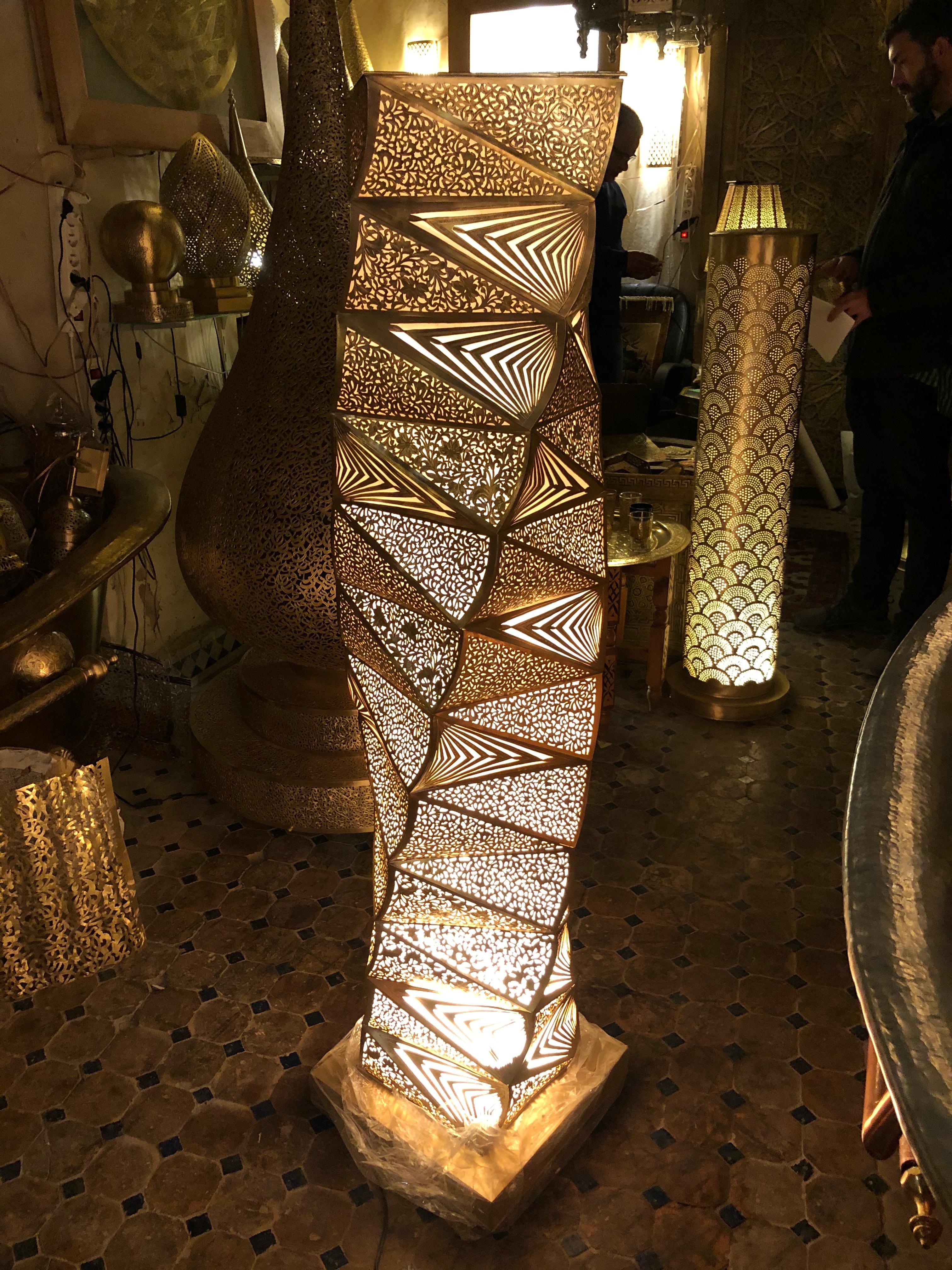 Custom designed for our 1stdibs clients

This fine floor lamp in our unique tower form design emits stunning light through over 100 hand cut and hand pierced copper panels- a wonderful accent in your decor with our without its electrifying lights