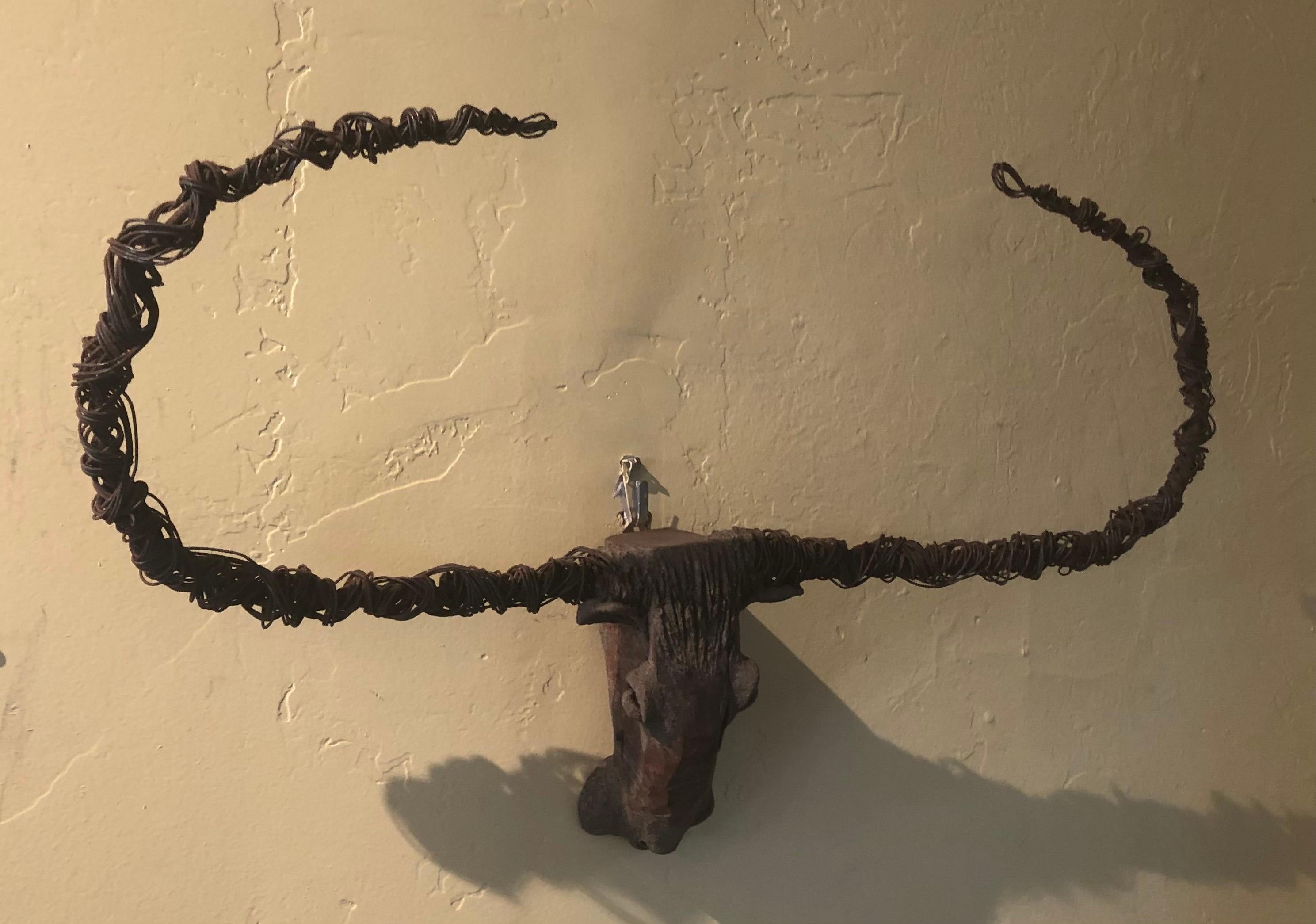 A super cool artisan handmade bull skull with horns sculpture made of pottery, wood and wire, circa 1990s. The piece has a great worn patina and measures 4.5
