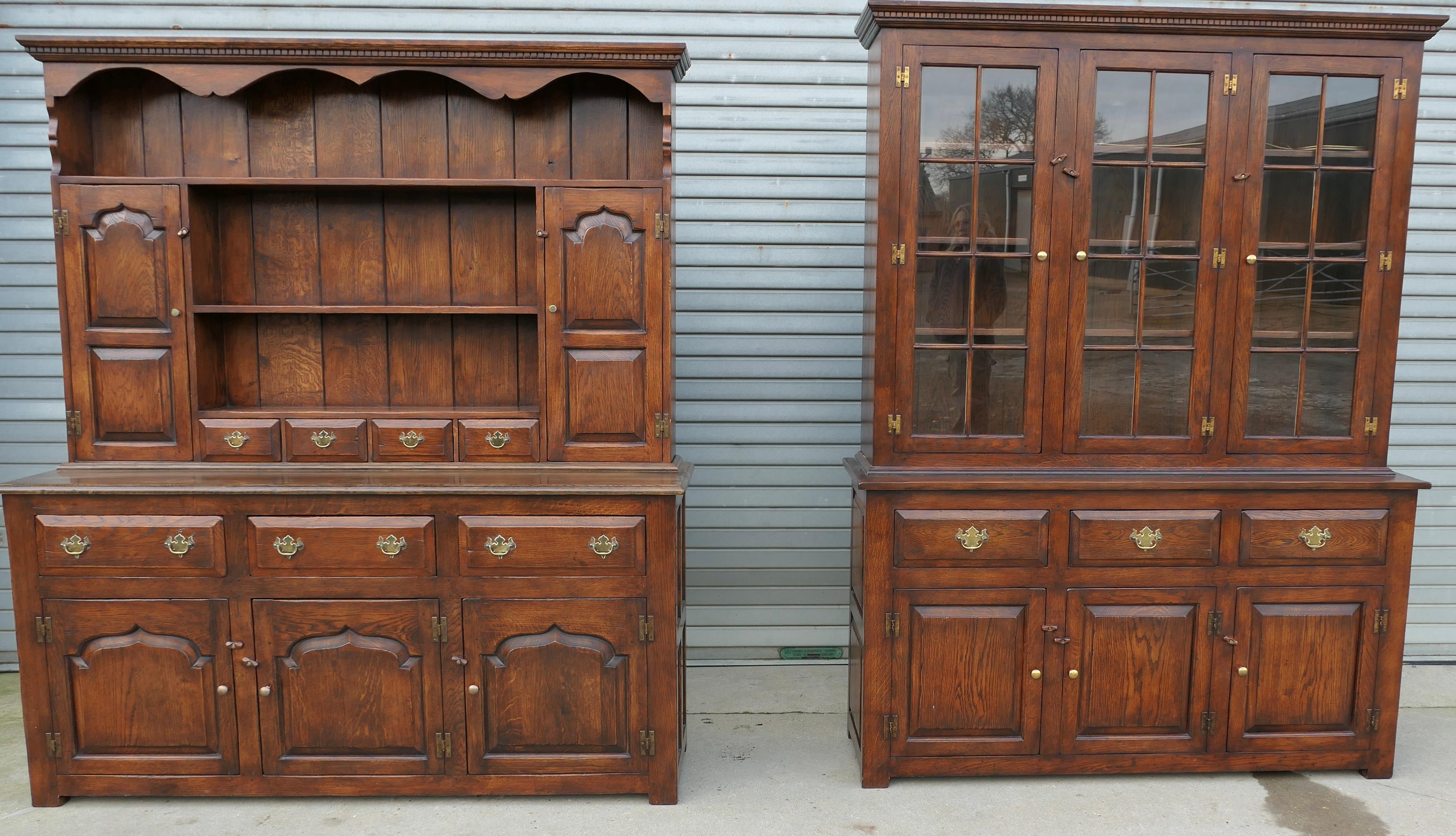 Artisan Hand Made Period Oak Style Dresser

A Superbly Crafted piece made in the Mid 20th Century in the English period style with a dental cornice, brass fittings and a solid oak planked back.
The upper section of the cupboard has 2 small shelved