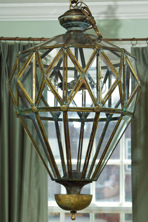 Handsome Italian brass hand-welded lantern, interior chandelier newly installed, made to appear antique.
 
Sold as electrified to code and install ready with matching brass chain and brass canopy (Additional to UL certify)
Place of