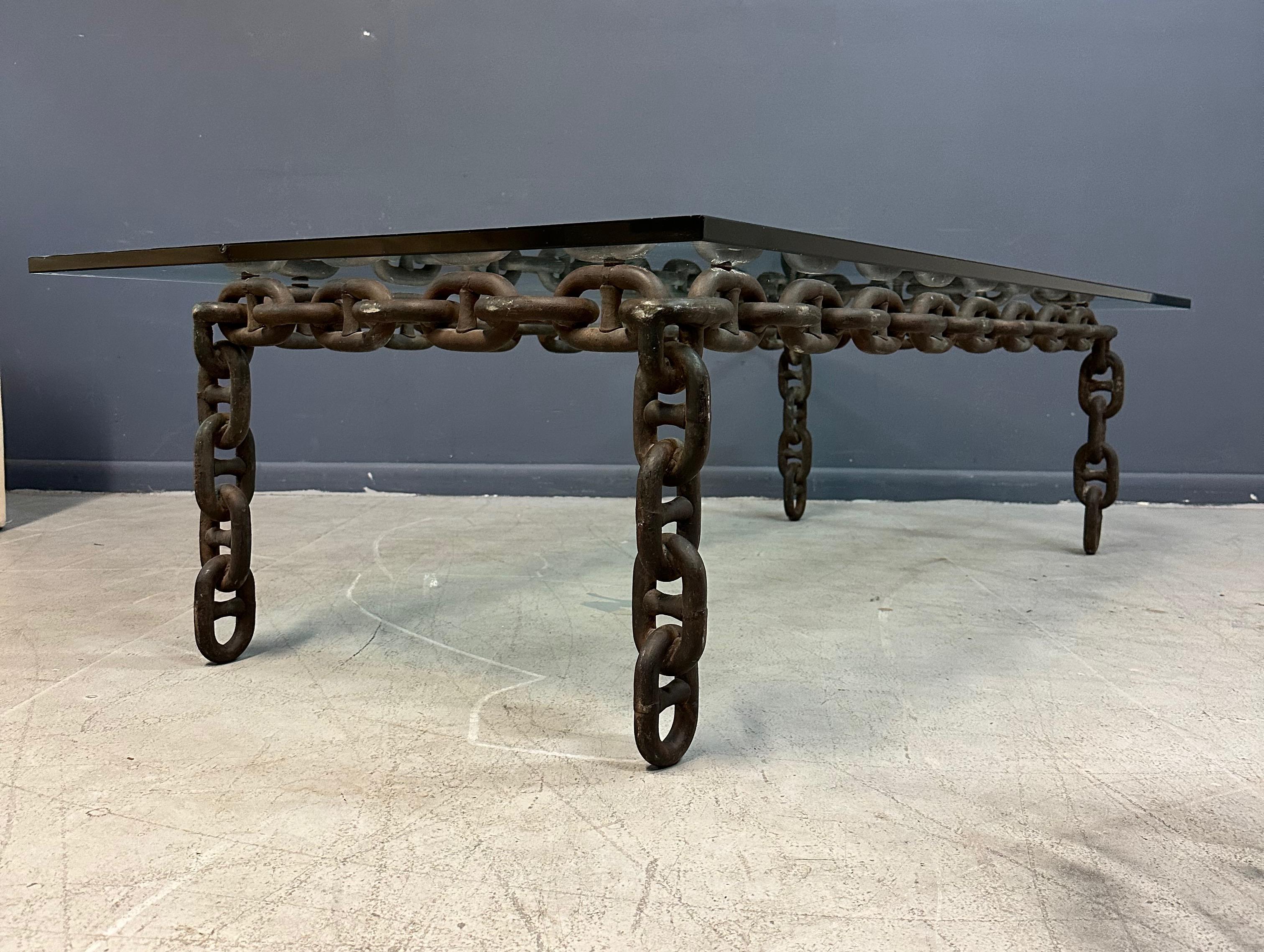 Awesome industrial style coffee table that legend says was used in the John Varvatos boutique in SoHo NYC. We have placed a large glass that overhangs the chain link, but if you prefer we can cut a new top that fits into the chain. This table would