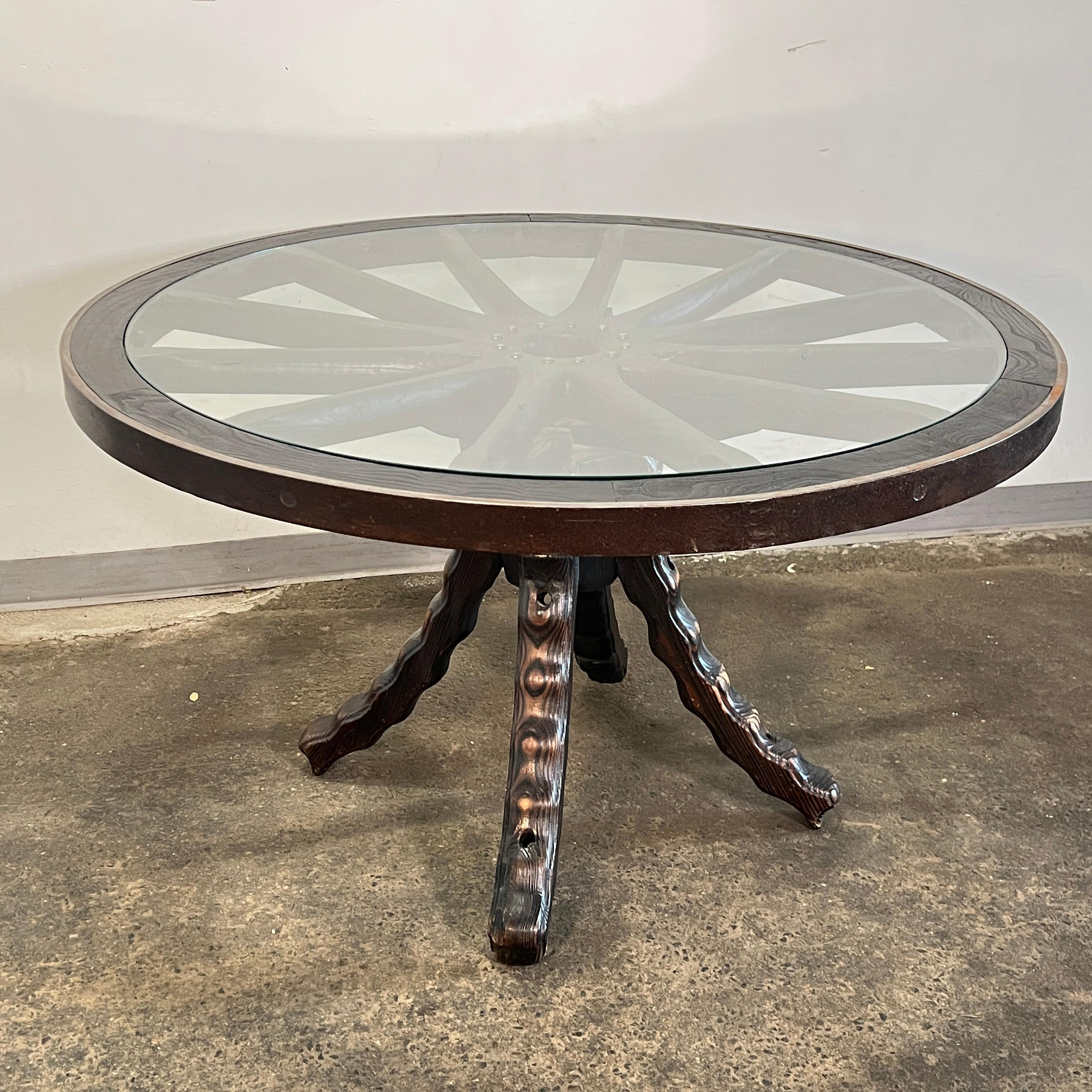 A rustic and Brutalist dining set, made in Catalonia, Spain, and purchased there in 1960. It features four brutalist style dining chairs and a pair of freeform pull up stools for added seating around a 51” round dining table, all carved from Spanish
