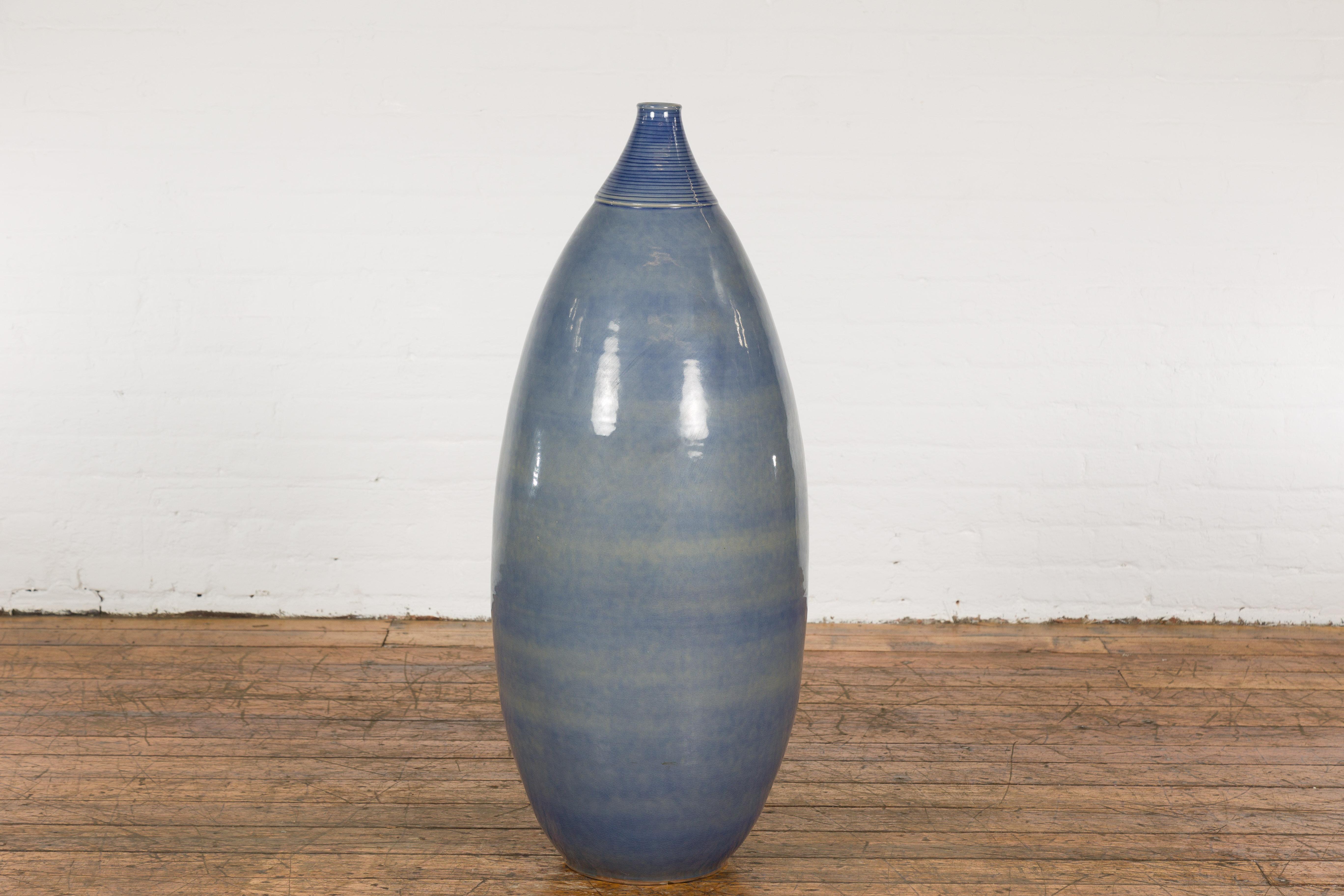 A tall Prem Collection ceramic artisan hand crafted vase with rounded lines. Experience the beauty of authentic, handmade craft with this tall ceramic vase from the Prem Collection. This piece of artisanal artistry blends form and function,