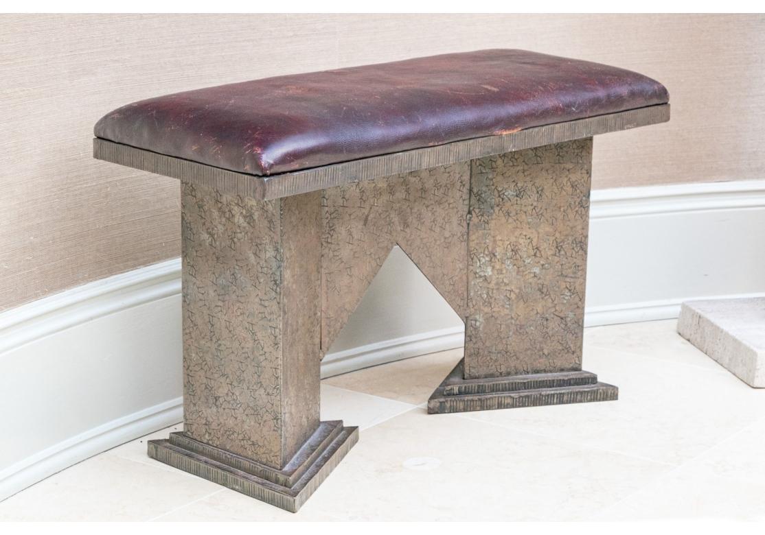 An Elemental design with references to the Arts and Crafts style. Contemporary leather upholstered bench having artisan hand crafted steel frame. The Bench has good weight and is very solid feeling. 

Condition: Wear to leather including scratches