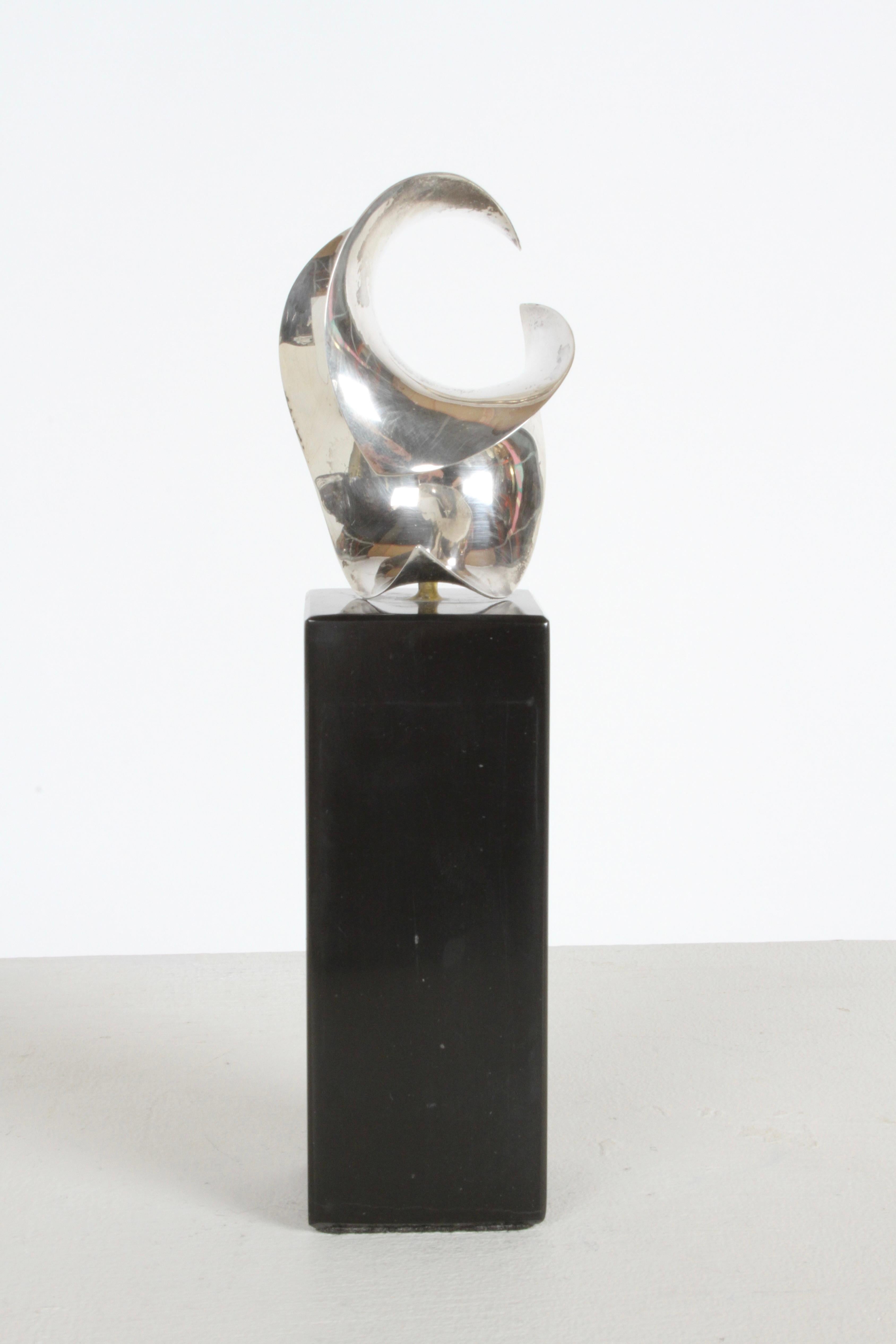 Sculptor and Jewelry Designer Michael Good designed and hand formed this sterling silver Hyperbolic Paraboloid sculpture on black marble base. Signed M.Good 925. In the Mid-Century Modern Style. 

Michael worked with famed Finnish-born American