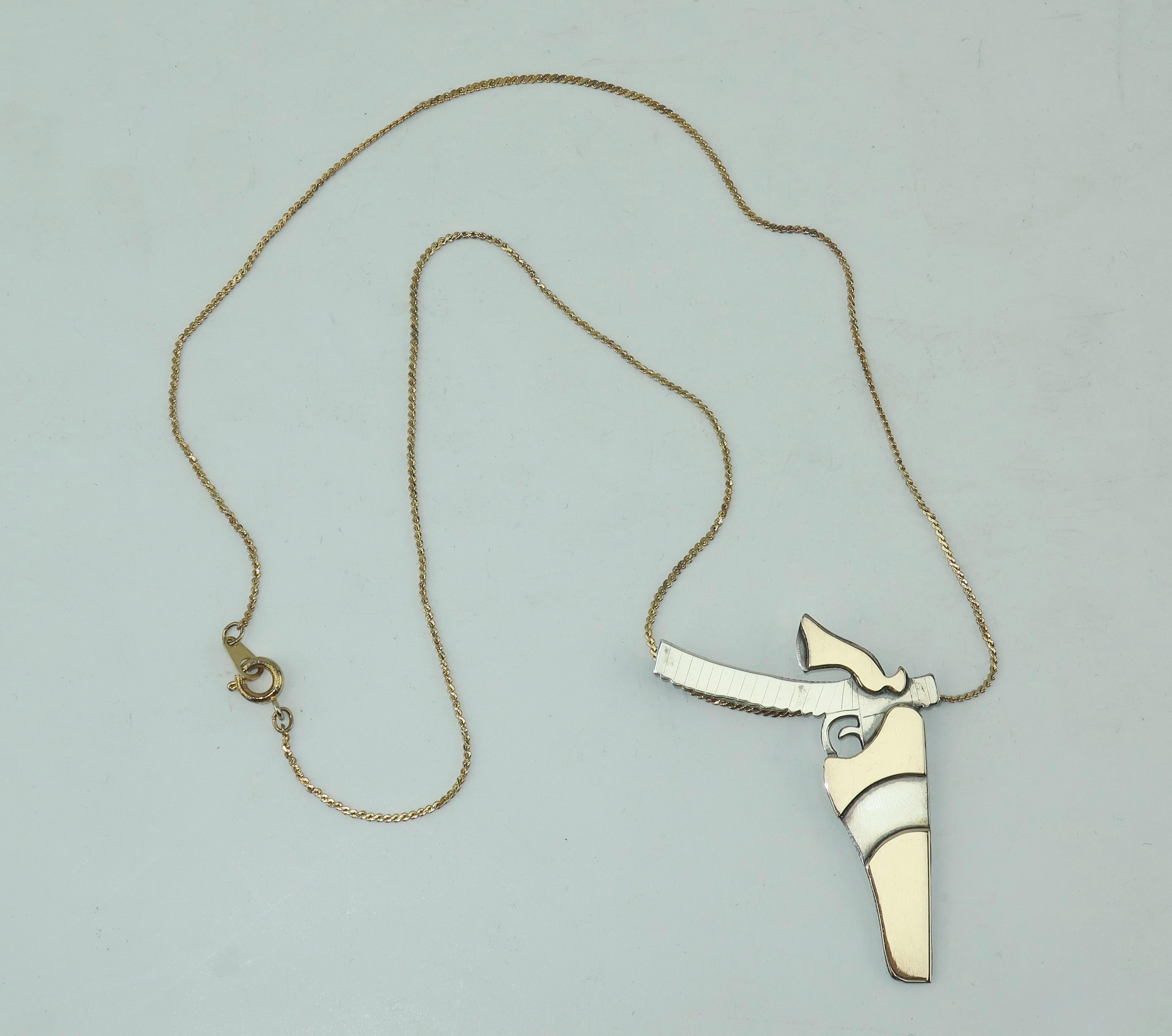 You don’t have to be a pistol packin’ mama to appreciate this modernist artisan sterling silver and brass gun pendant.  The graphic lines and minimalist details make this accessory a real conversation piece.  A natural paired with Western wear or a