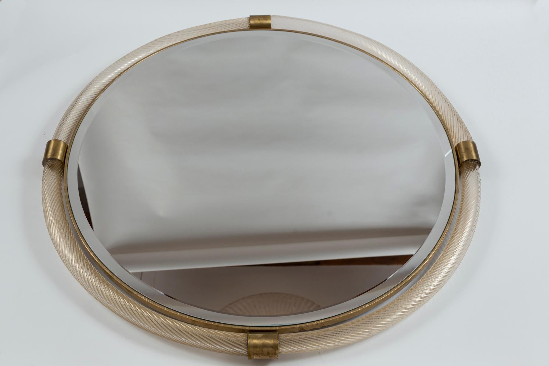 Murano glass blown 23k gold transparent torchere tubes joined by unlacquered brass fittings to form a lovely circular mirror with bevelled looking glass

Origin: Murano, Italy

Condition: Very Good

Dating: Contemporary, commissioned by