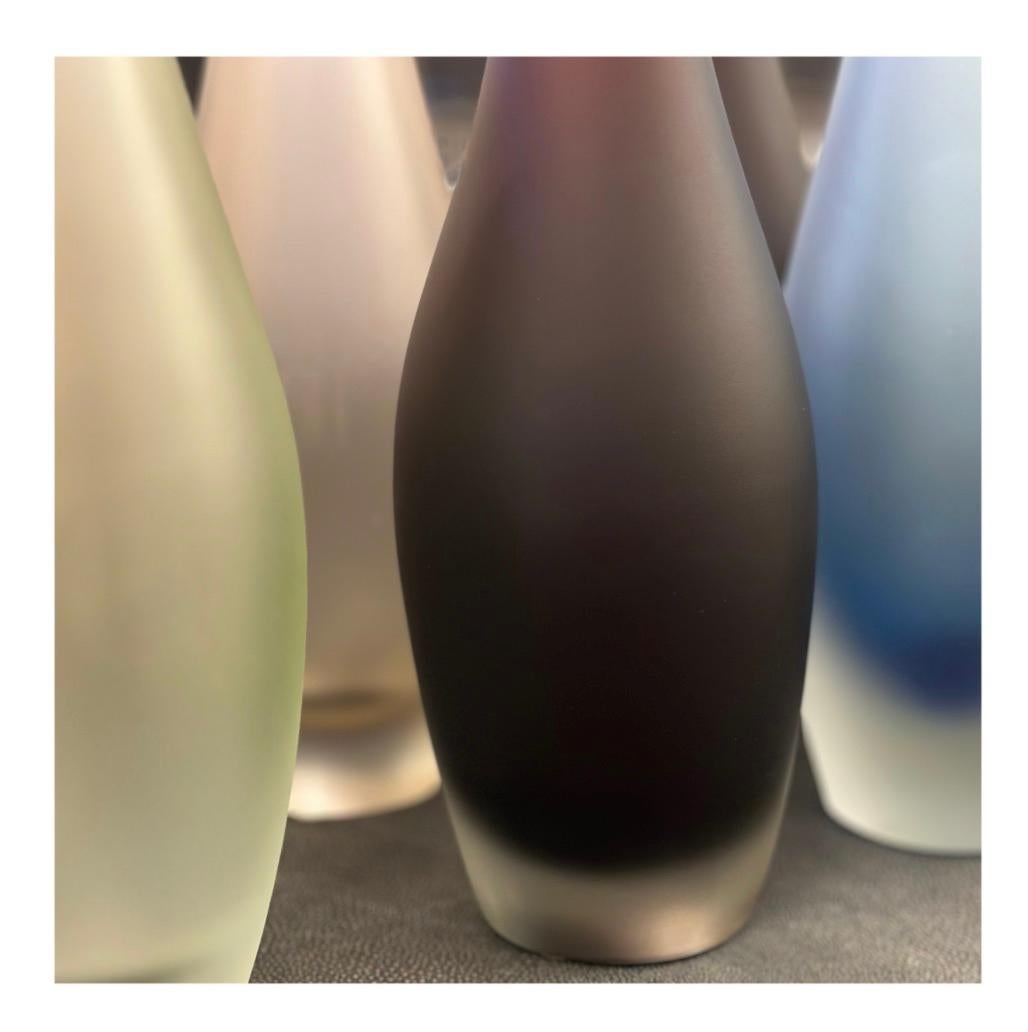 Whether displaying one or a collection, the elegant Alto Vase is certain to be noticed. Each long-neck vase is made using the traditional Sommerso technique, creating a stunning tone-on-tone effect that makes each appear to glow from within. They