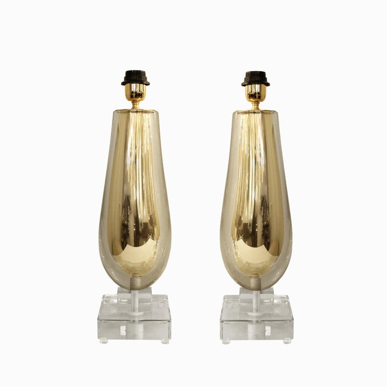 Elegant pair of Murano sommerso table lamps in clear and gold aventurine glass with glass base & brass hardware. Italy, 2022. Lamp shades sold separately.
