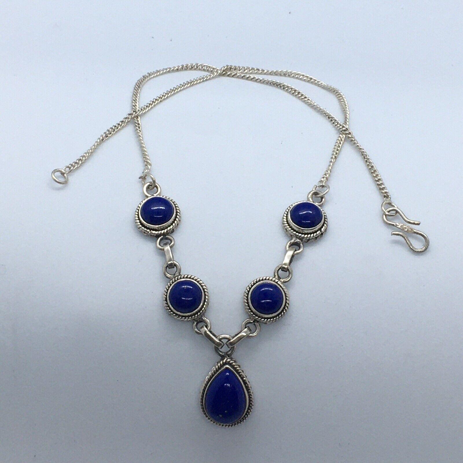 Artisan Sterling Silver Chilean Round & Pear Shape Cabochon Lapis Lazuli Necklace

Length 18.5 Inch   
Condition no evidence of repair 