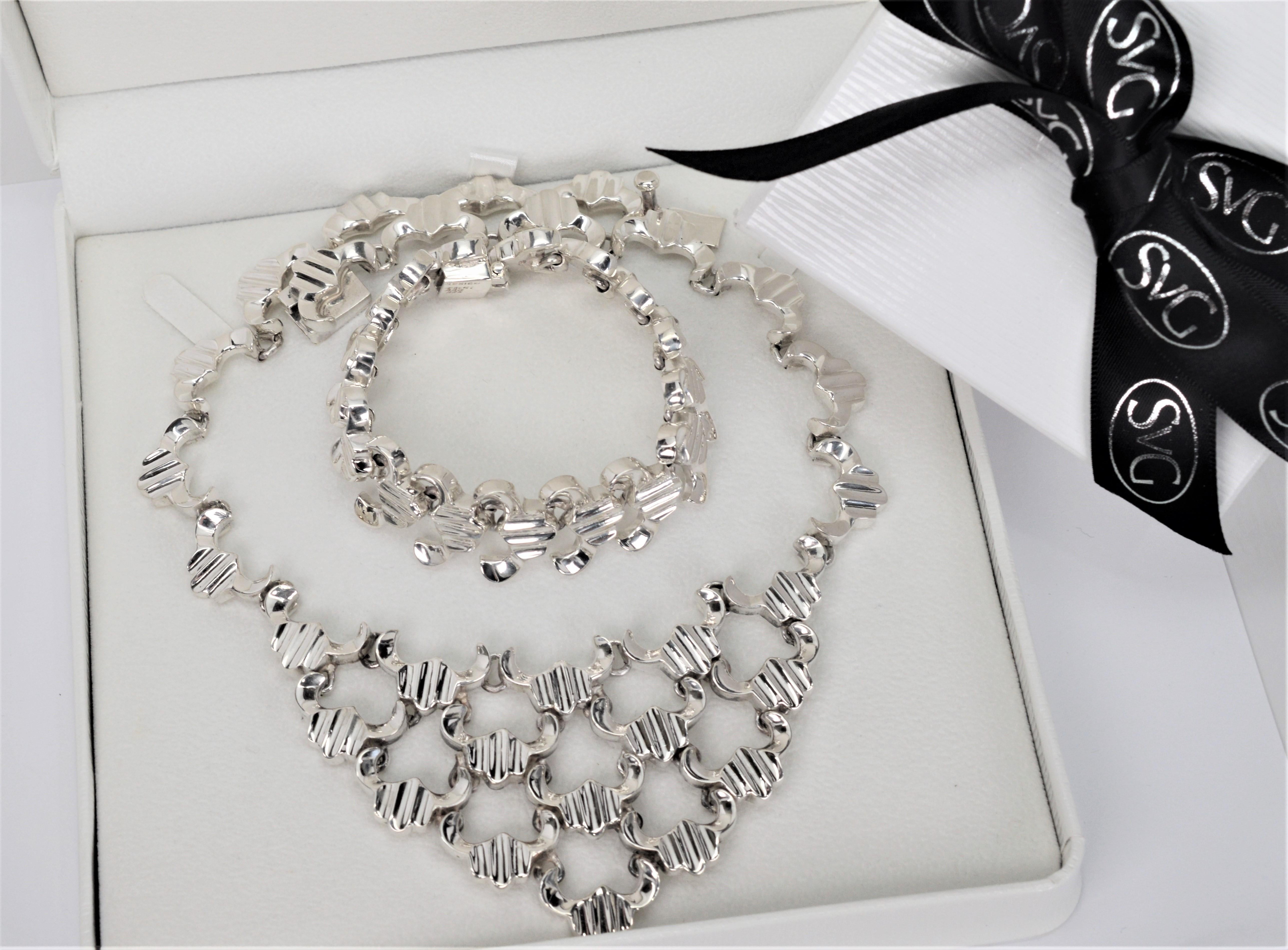 Dramatic in sterling silver, this necklace and bracelet set makes a bold design statement when accessorizing and elevates your casual look or that little black dress. Skilled Mexican silversmithing is evident in the forged 1/2 inch links that