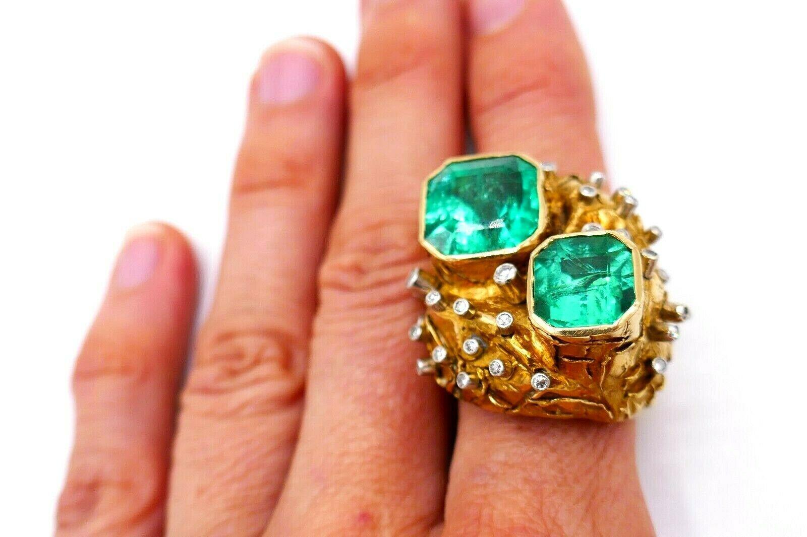 Whimsical yet massive 18k yellow gold cocktail ring featuring two octagonal shape emeralds and round cut diamonds. Step cut emeralds have a GIA report (see pictures for details), they are Colombian, with minor to moderate clarity enhancement. Gold