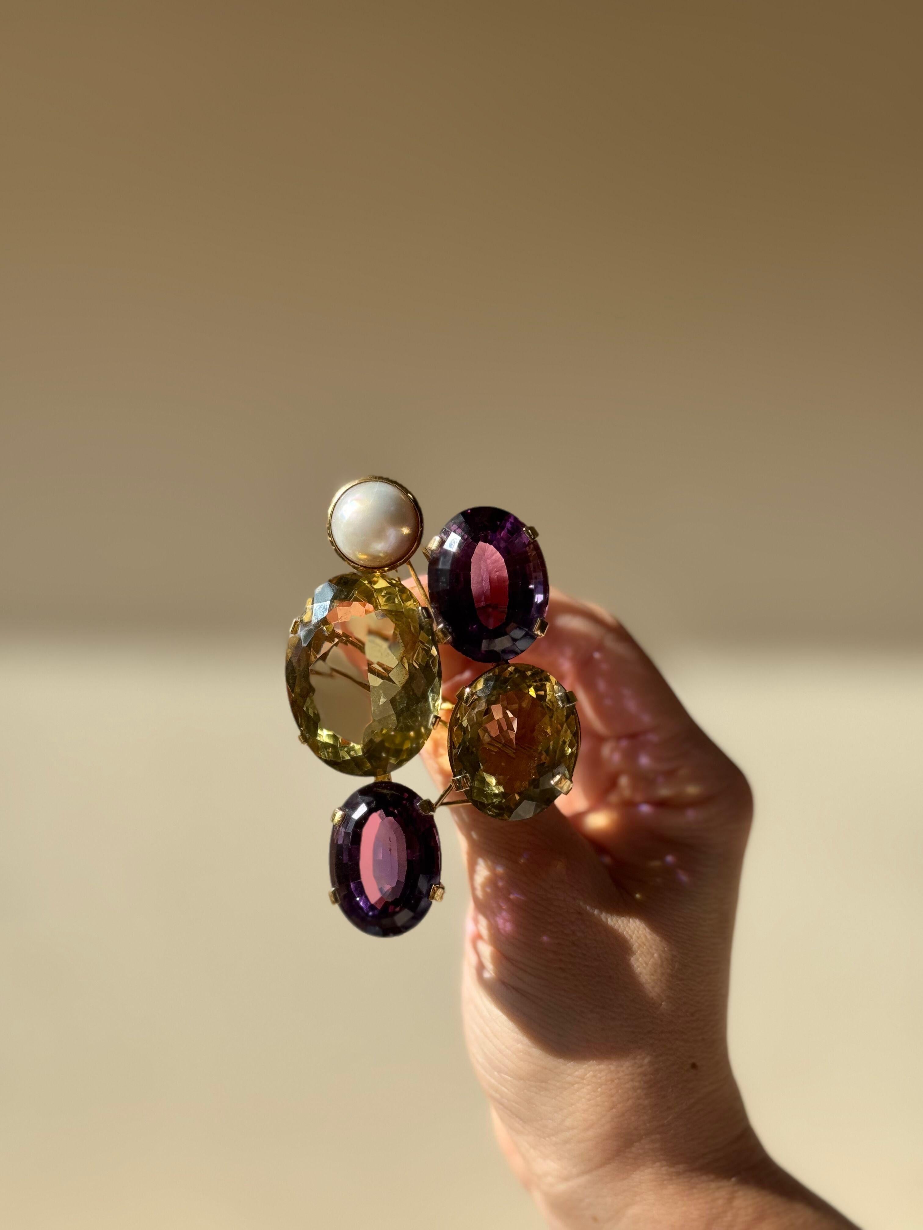 Designer signed artisanal 14k gold large brooch pendant, set with amethyst and citrines, and one pearl.

Brooch measures 3 3/8