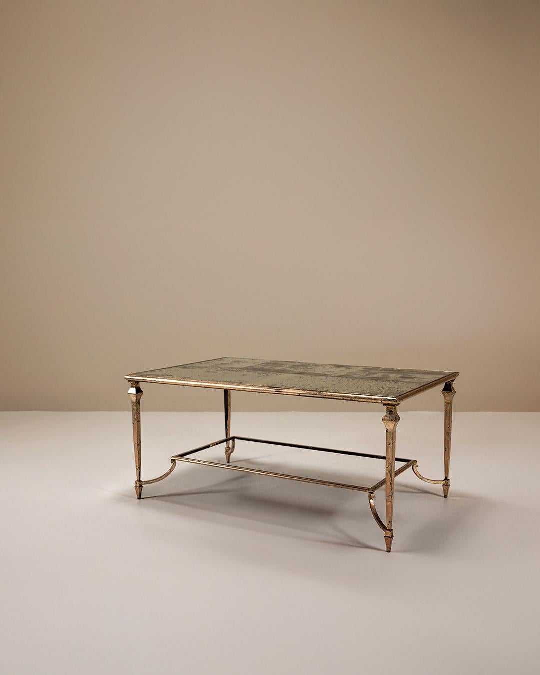 In our ongoing search for crafted design that balances refinement with character, we present this artisanal coffee table in the spirit of Maison Jansen.

Design
The table is built on a hand-forged metal frame with a deliberate silvered patine