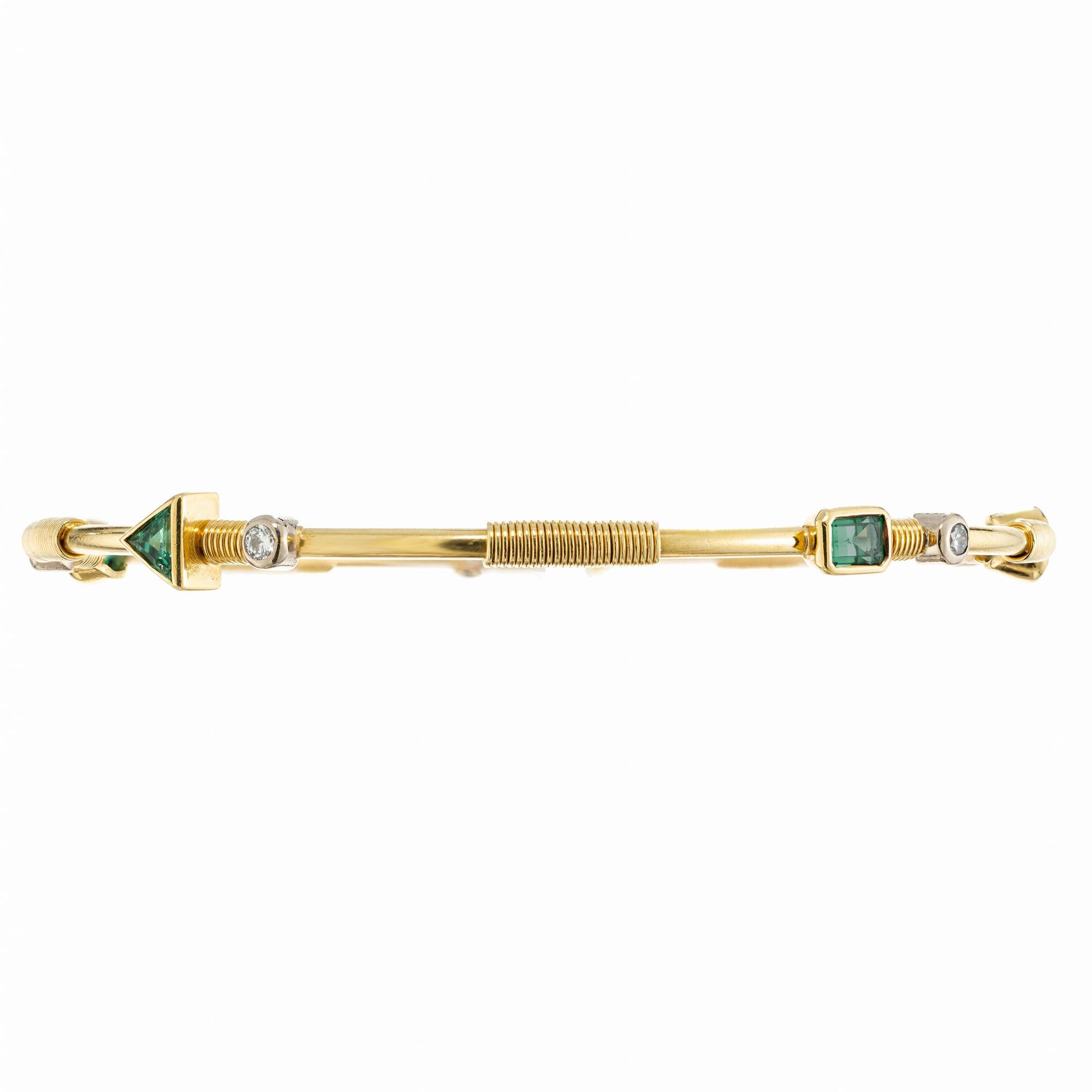 Artisanal handmade genuine multi shape Emerald gold bangle bracelet. This unique hand crafted 18k yellow gold slip on bangle is adorned with a mix of round, triangle, oval, rectangle and emerald cut diamonds and emeralds. Each section in-between is