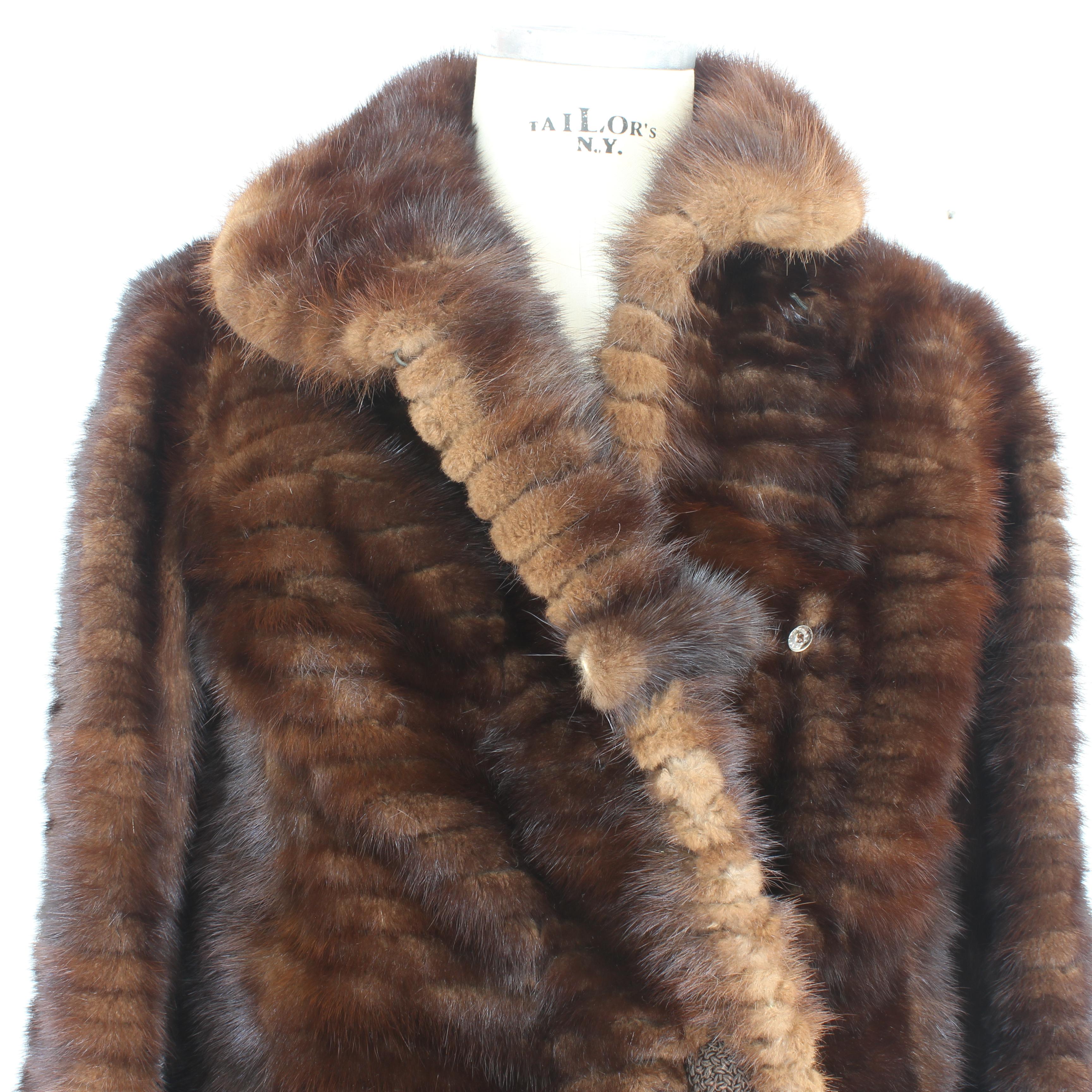 This exquisite vintage 1980s French brown mink fur coat is a true testament to master craftsmanship and luxurious fashion. Handcrafted in France, it features the finest mink fur, renowned for its softness, warmth, and lustrous texture. The coat's