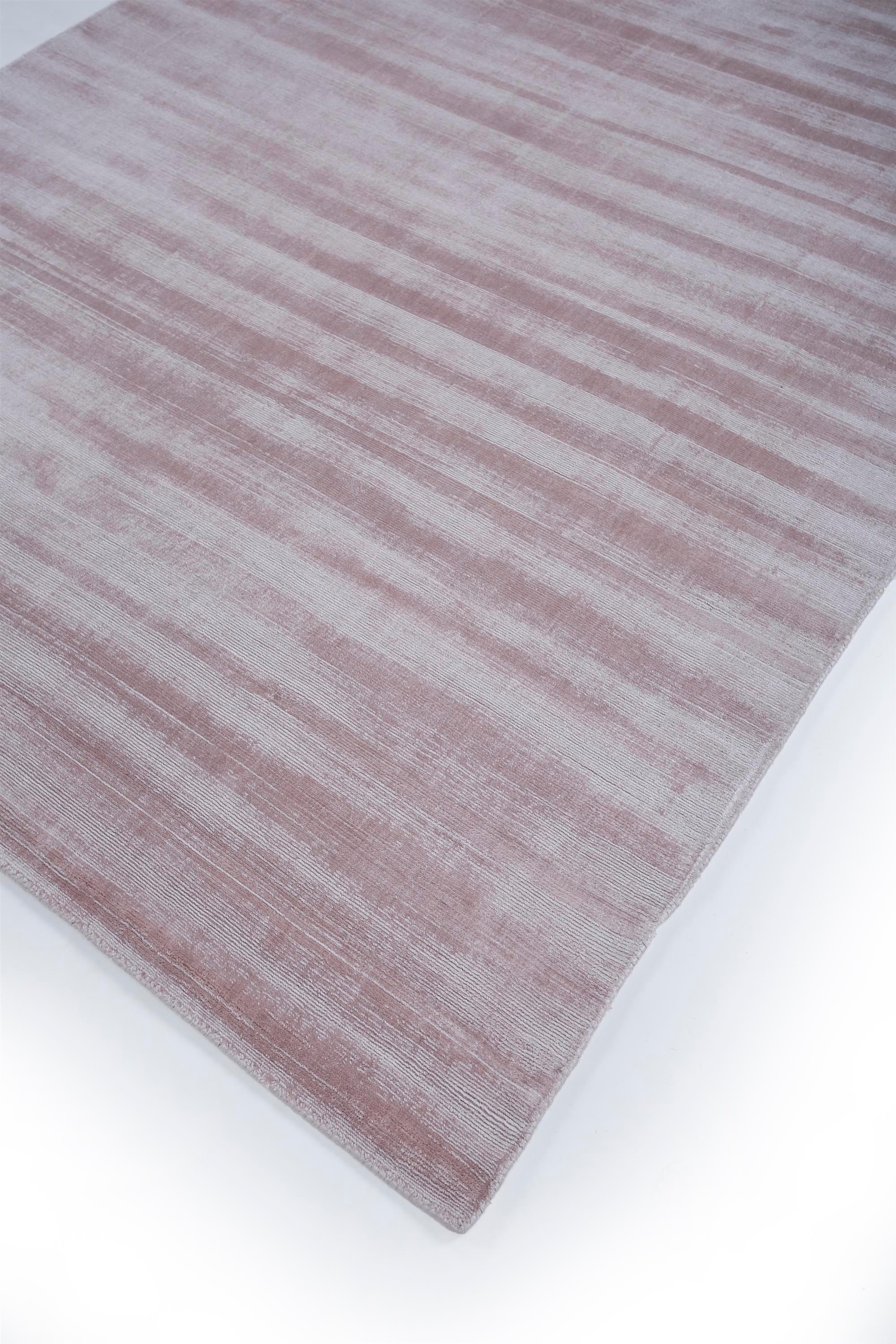 What whispers of sophistication and tranquility does this modern marvel bring into your space? Crafted with finesse and passion by skilled artisans, this hand-loomed rug transcends simplicity to embody elegance and clarity. Its lightly-distressed