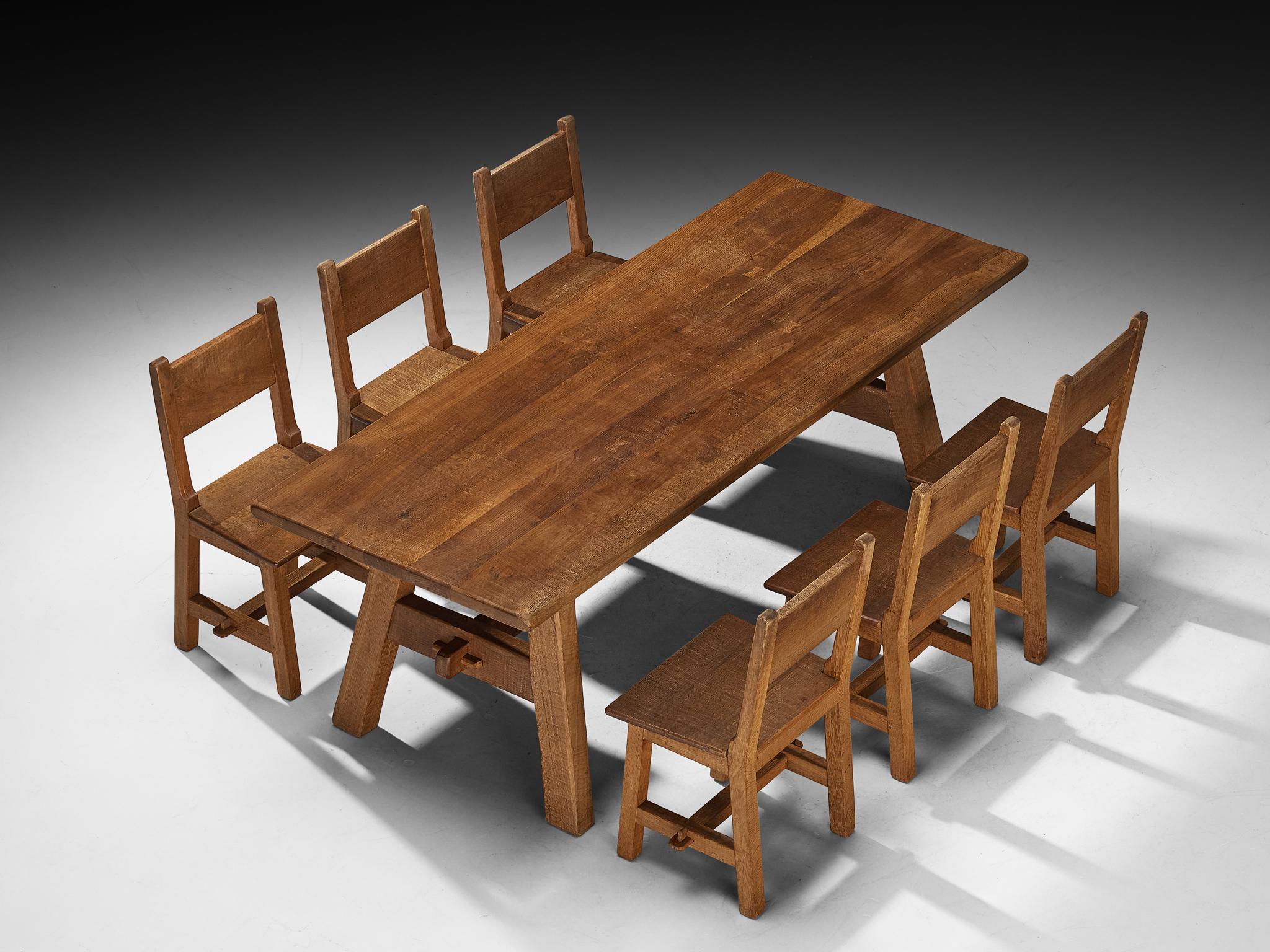 Dining set with table and chairs, Europe, 1950s

This dining set, consisting of a table and four chairs, crafted in solid oak, reflects a clear balance between rustic simplicity and modern restraint. Its straightforward construction highlights the